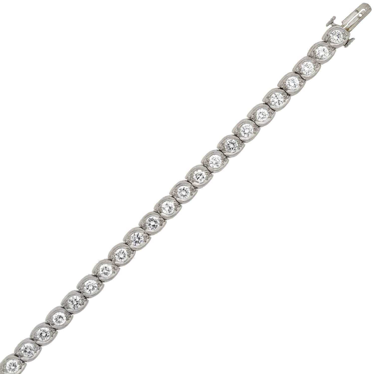 A stunning diamond line bracelet from the notable American jewelry maker J.E. Caldwell & Co.! From the late Art Deco (ca1930s) era, this wonderful piece is crafted in platinum, and comprised of 45 Transitional Cut diamond accented links, creating a