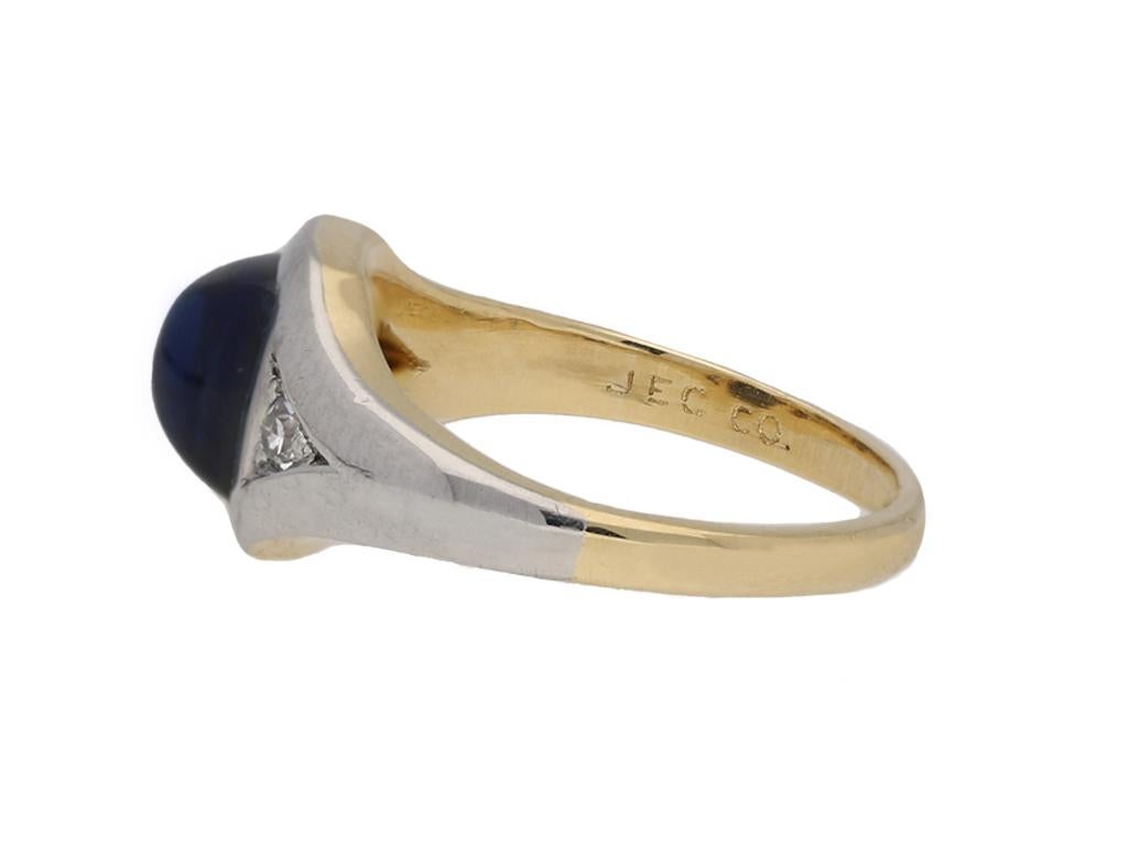 J.E. Caldwell sapphire and diamond three stone ring. Set with a cushion shape cabochon natural unenhanced sapphire in an open back rubover setting with an approximate weight of 1.20 carats, flanked by two round eight cut diamonds in open back grain