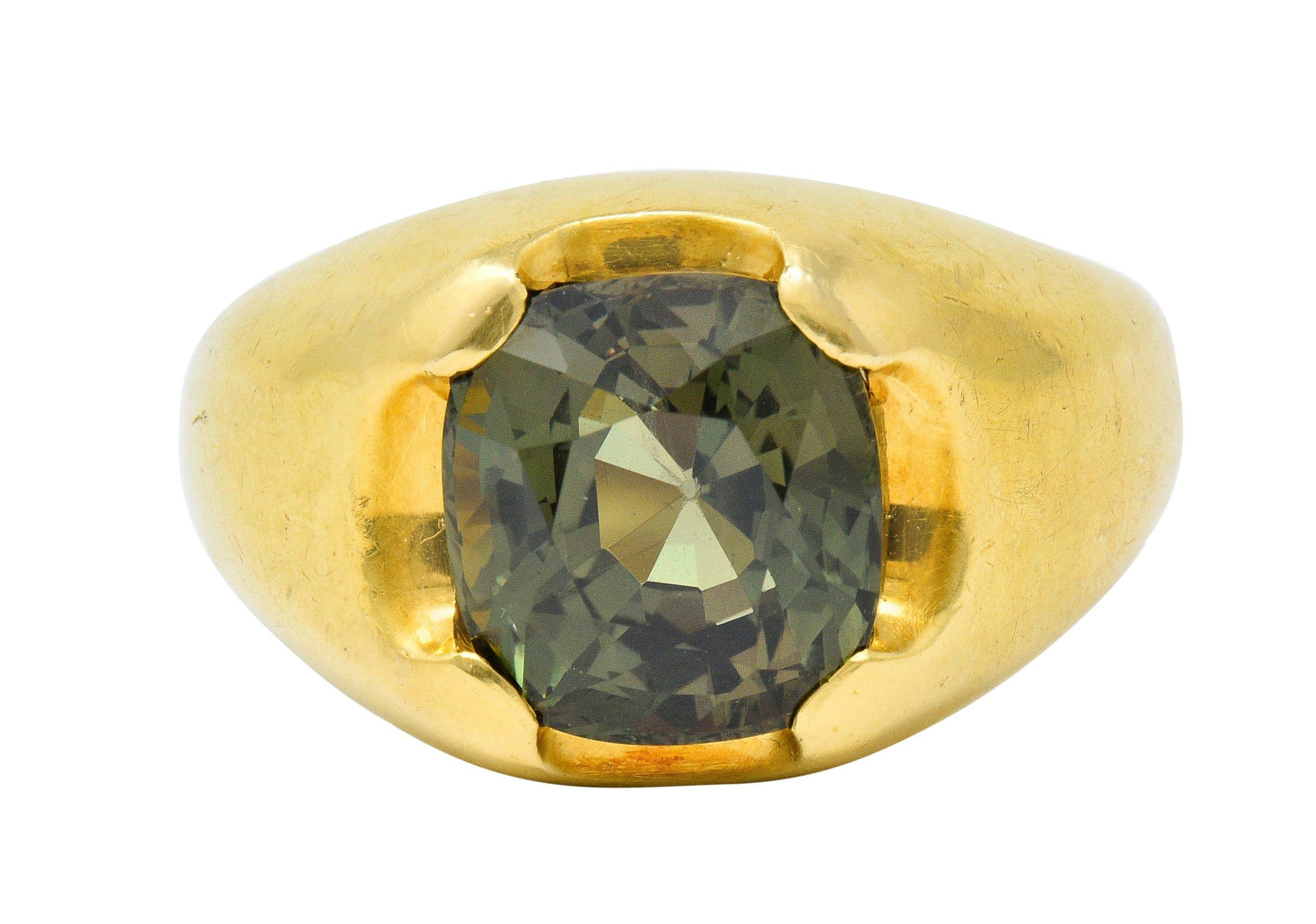 Satin finished mounting centers a cushion cut alexandrite chrysoberyl weighing approximately 6.20 carats

Exhibiting strong color-change with medium-dark green color in fluorescent light and brownish-orange in incandescent light

Set by wide prongs