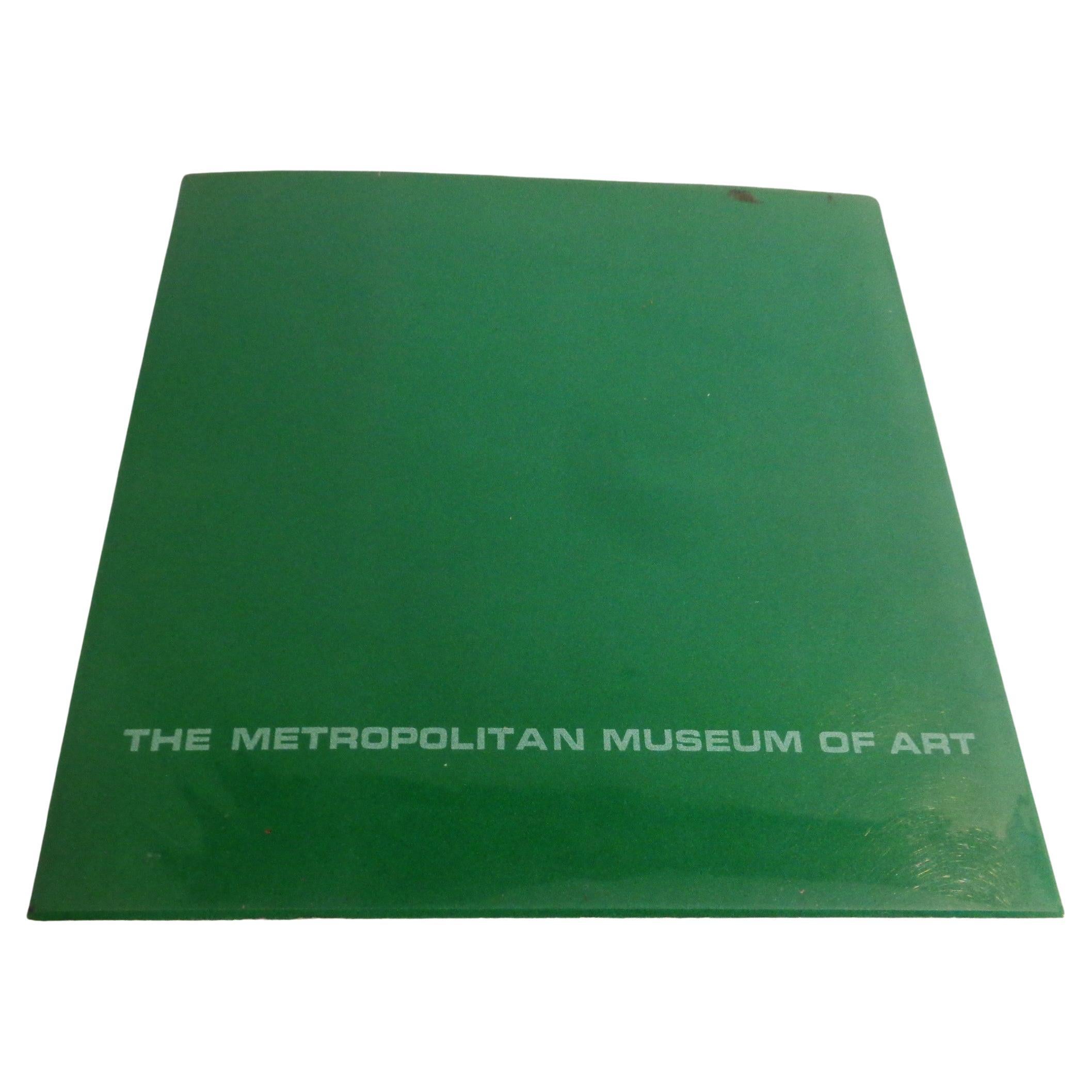 Jean Arp - At The Metropolitan Museum of Art - 1972 - 1st Edition. From the collection of Mme Marguerite Arp and Arthur and Madeleine Lejwa. Soft cover green card book with original acetate wrapping - the cover decorated w/ a silver die cut of a