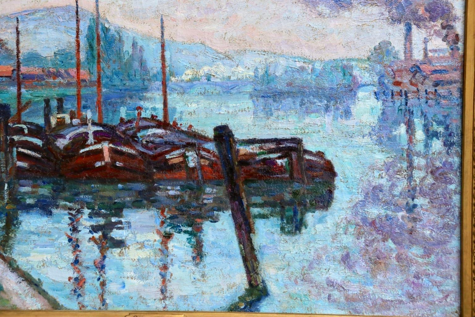 A magnificent oil on canvas by Jean Baptiste Armand Guillaumin depicting boats moored on the River Seine in Rouen, with smoking chimney stacks in the distance and rolling hills beyond. Signed lower left and titled & dated verso.