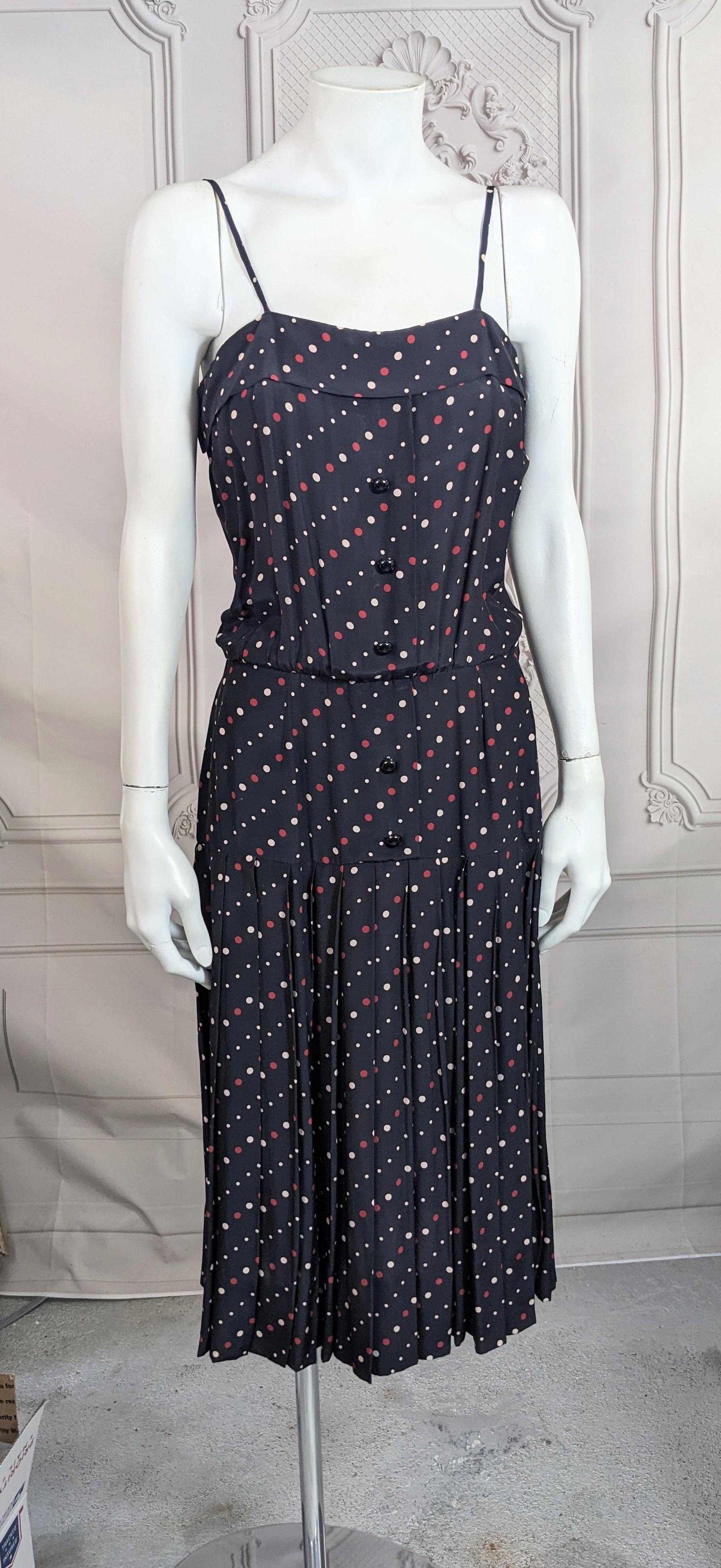 Easy Jean Baptiste Caumont Day Dress of polka dot print silk crepe from the 1980's. Charming design with faux button front and full pleats releasing from hips. 
J. B. Caumont created elegant designs in the 1980's and 90's from both Italy and NY. His