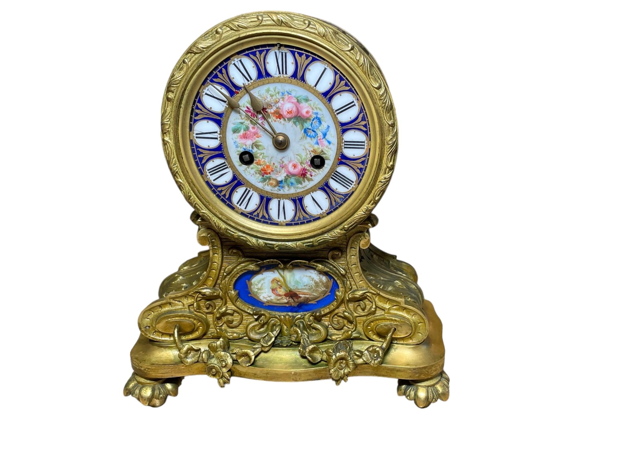 Jean Baptiste Delettrez Sevres Porcelain Gilt Bronze Mounted Drum Head Clock. It depicts a spherical royal blue porcelain dial with hand painted black Roman numbers in a round white background alternated by gilt leaves. Its center is decorated with