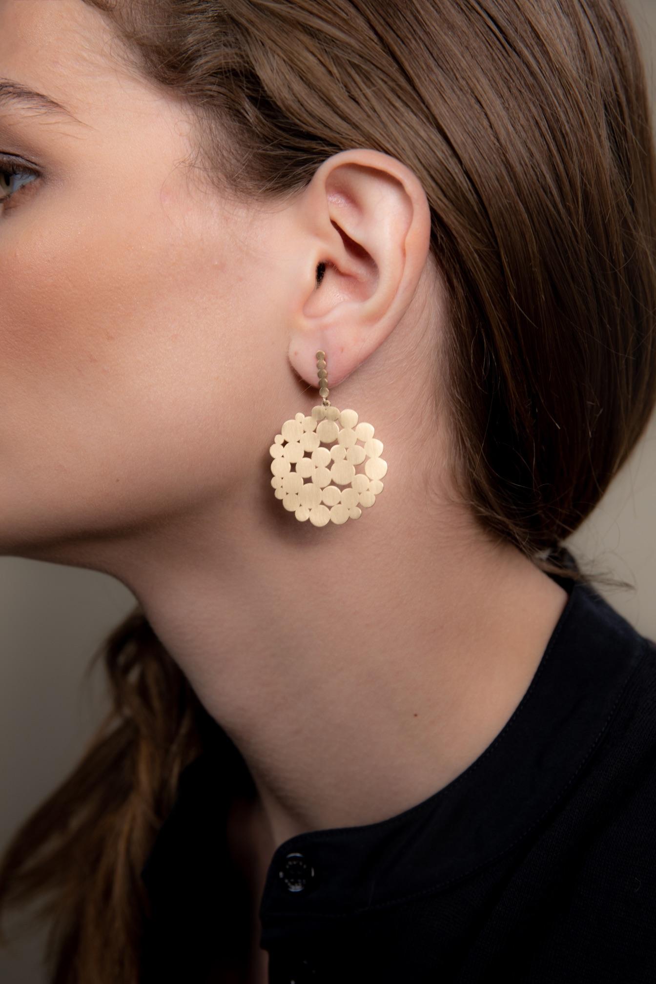 They very fun and versatile multi-circle gold post earrings are a statement piece for the one wearing them. They are 14K yellow gold with a textured brush finish to give it a little extra interest. Diameter is 1.25 inches and the length is 1.75