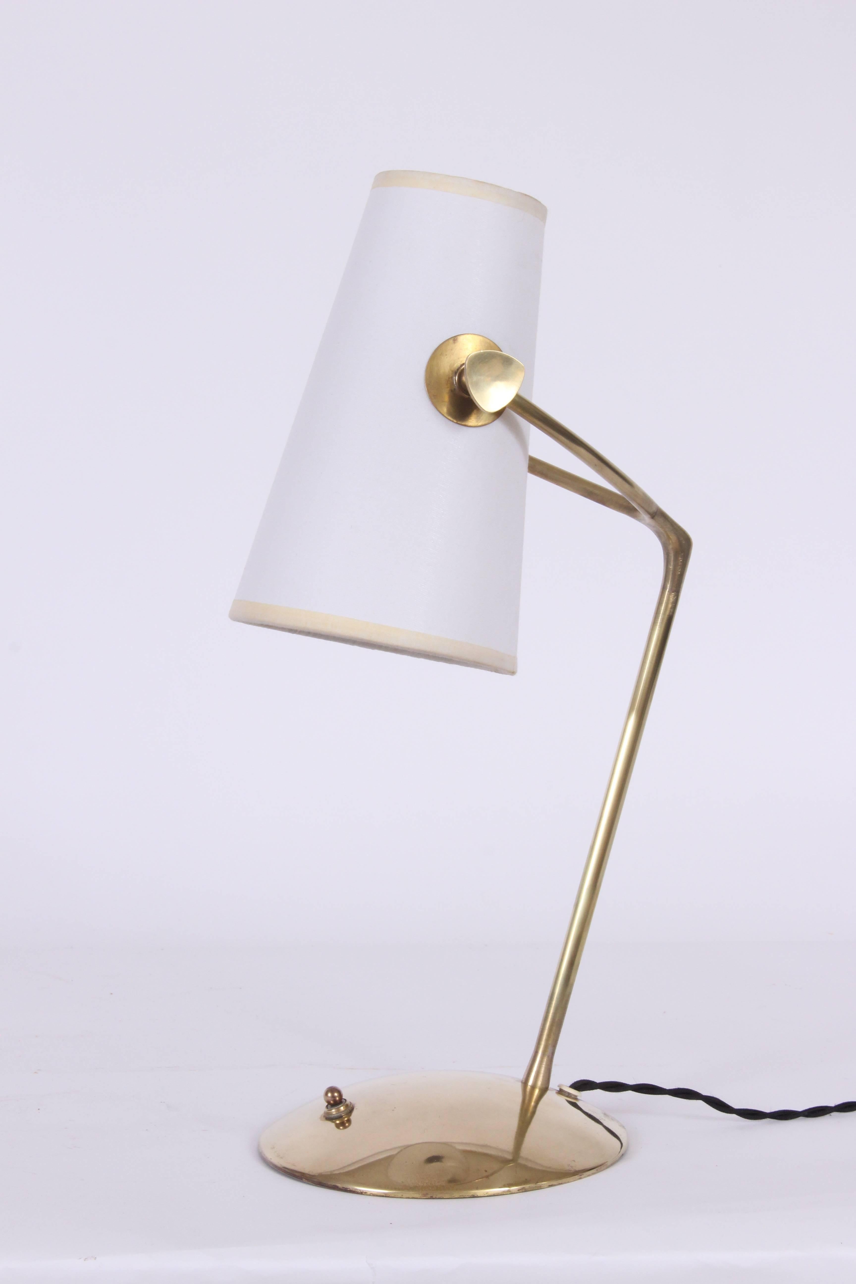 French Modern Boris Lacroix attributed adjustable brass reading table lamp. Finely handcrafted brass wishbone form with brass knobs to adjust the newly replaced white paper shade on rounded base. With base switch. Measures: (Shade 8H x 3D top and 5D