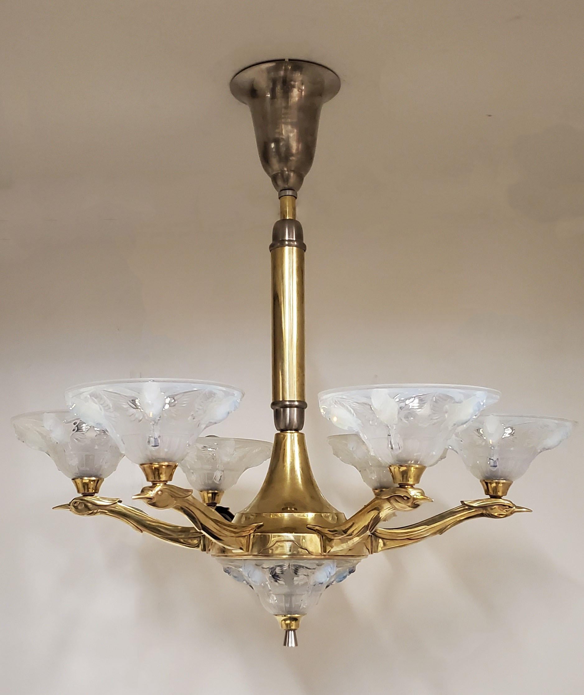 A striking original French Art Deco heavily molded opalescent art glass chandelier circa 1930,  by Jean Boris Lacroix featuring a dramatic and organic design with six sinuous arms portraying birds in flight.  Signed LA+ on each shade
1902-1984 Jean