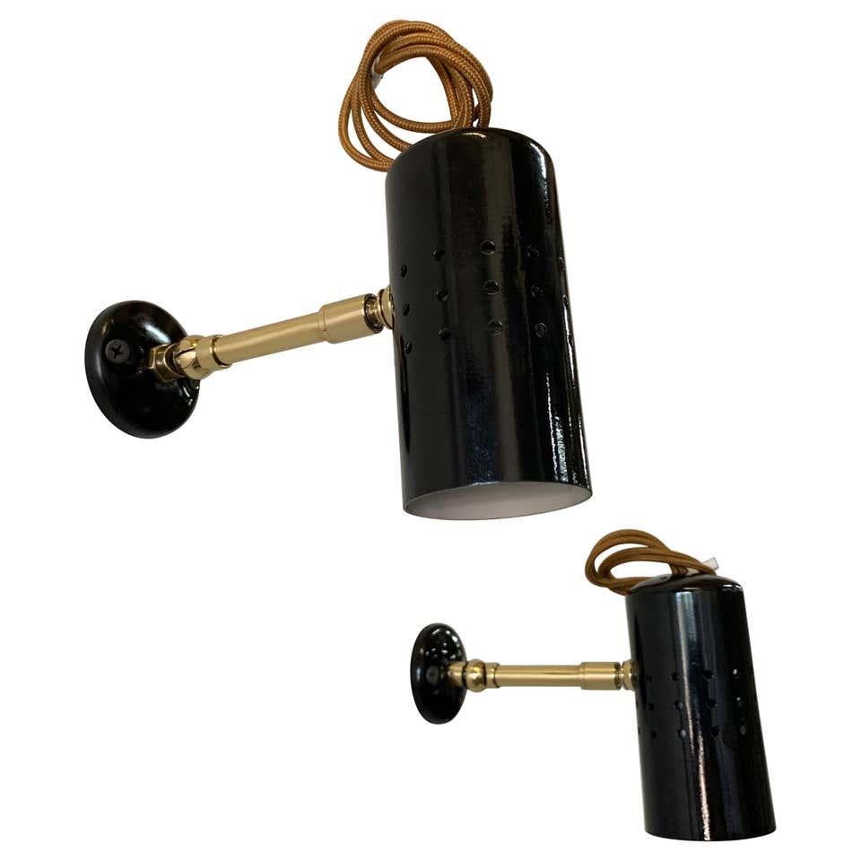 These wonderful vintage wall spotlights, with articulating head, brass arms and painted perforated metal diffusers.