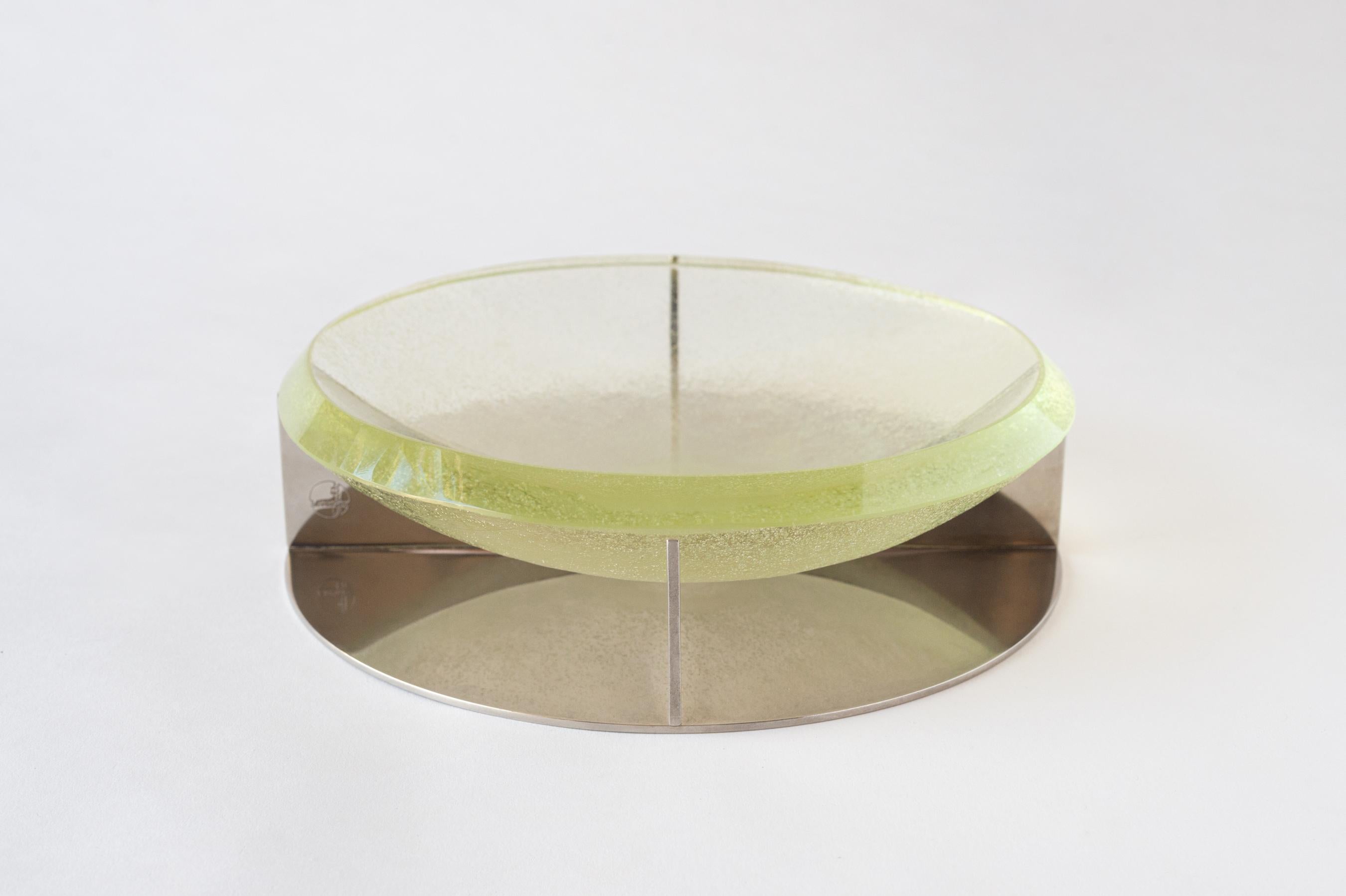 A large modernist vide poche, dish, or fruit bowl comprised of a sand-cast glass dish resting on a nickel-plated metal base. During the 1930s, Jean Boris Lacroix (1902–1984) perfected his use of glass and metal, transforming “industrial” grade