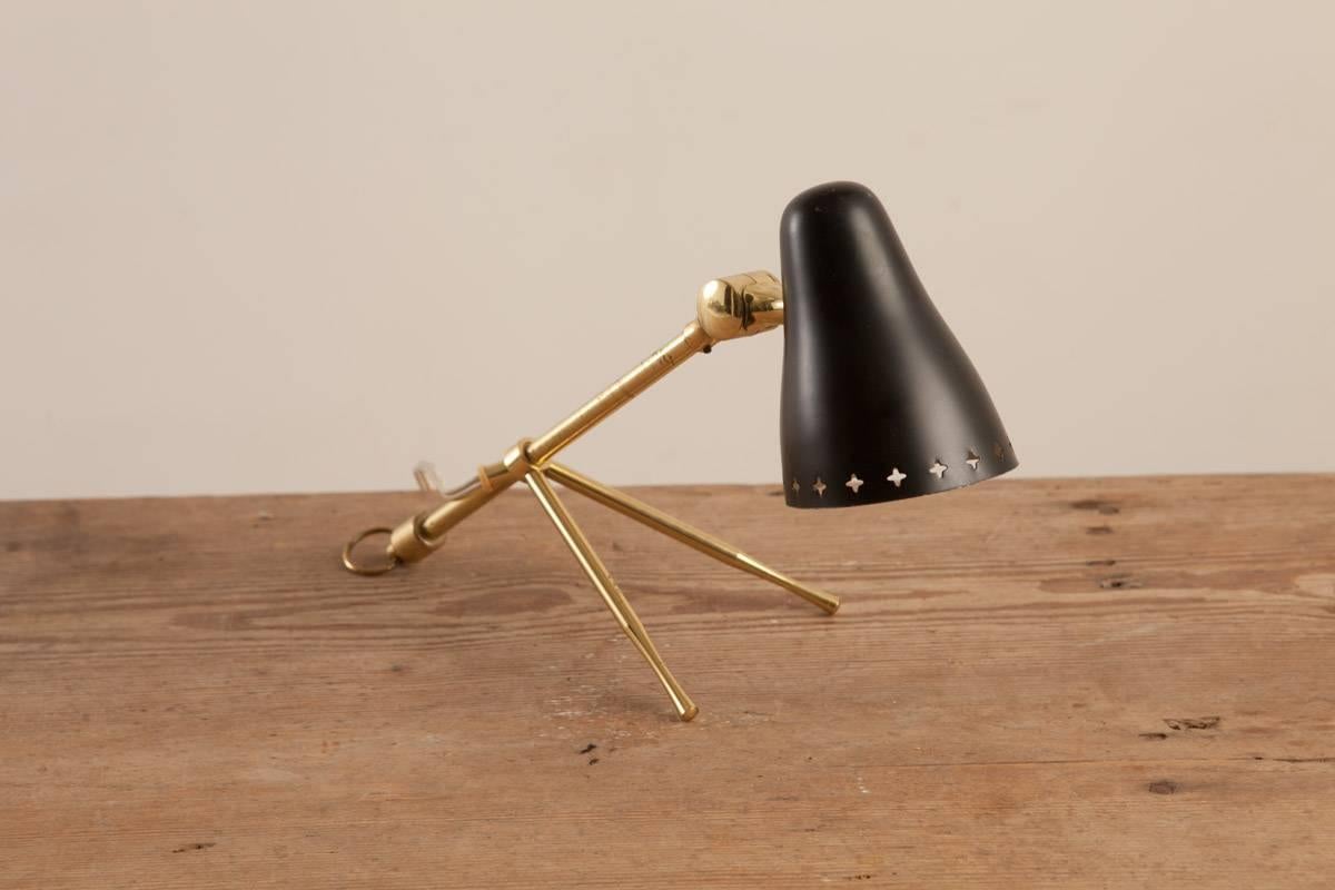 Boris Lacroix (1902 France 1984), French table lamp, circa 1950, origin: France. Tripod brass base with black metal painted shade with elegant perforated edge.