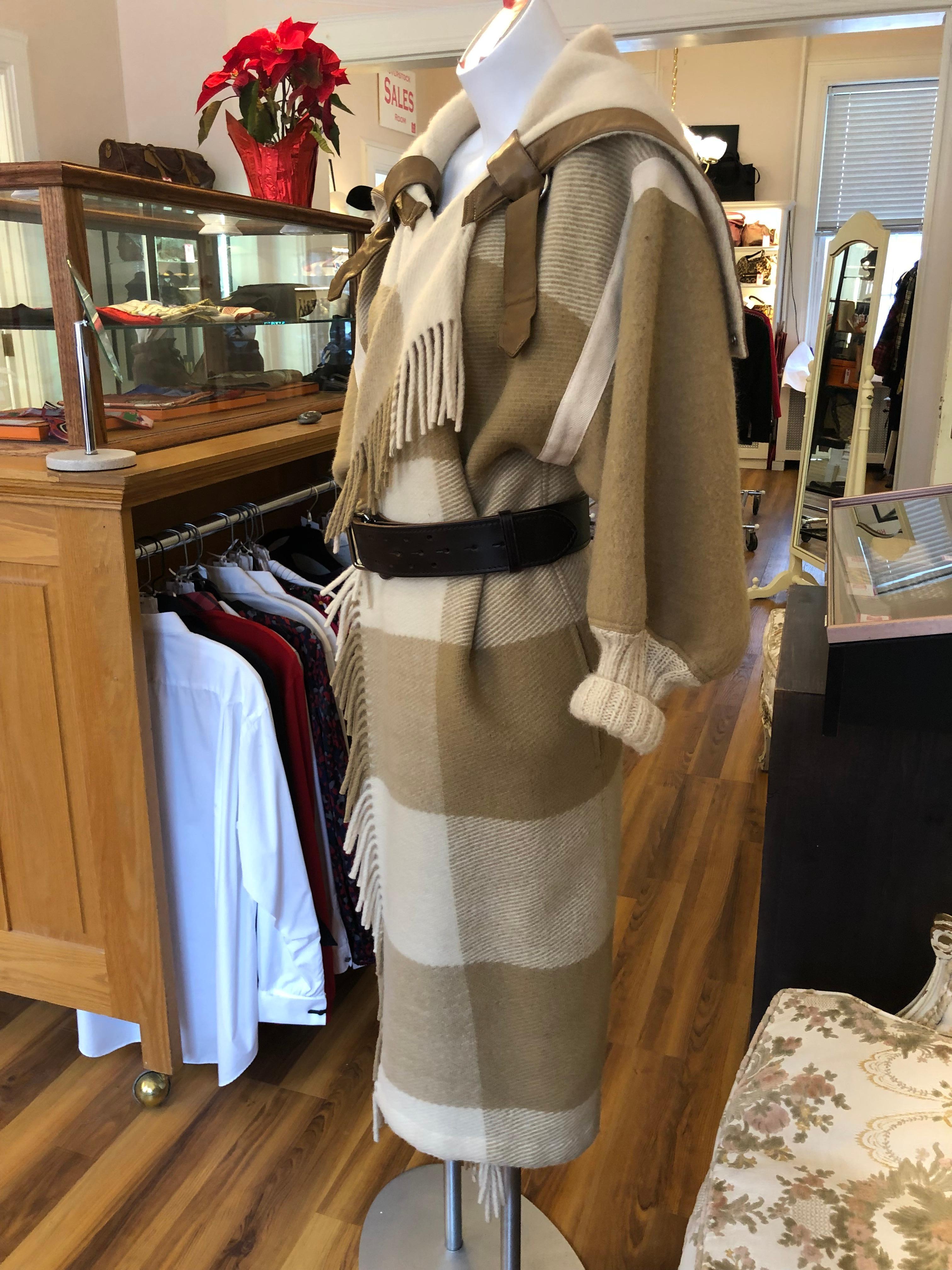 Iconic coat from avant garde designer Jean-Charles de Castelbajac. This 1980s wool fringed wrap blanket coat is so cozy and warm. The coat has wide lapels; ribbed cuffs; has two deep pockets, and a back panel which can be left down or use the snaps