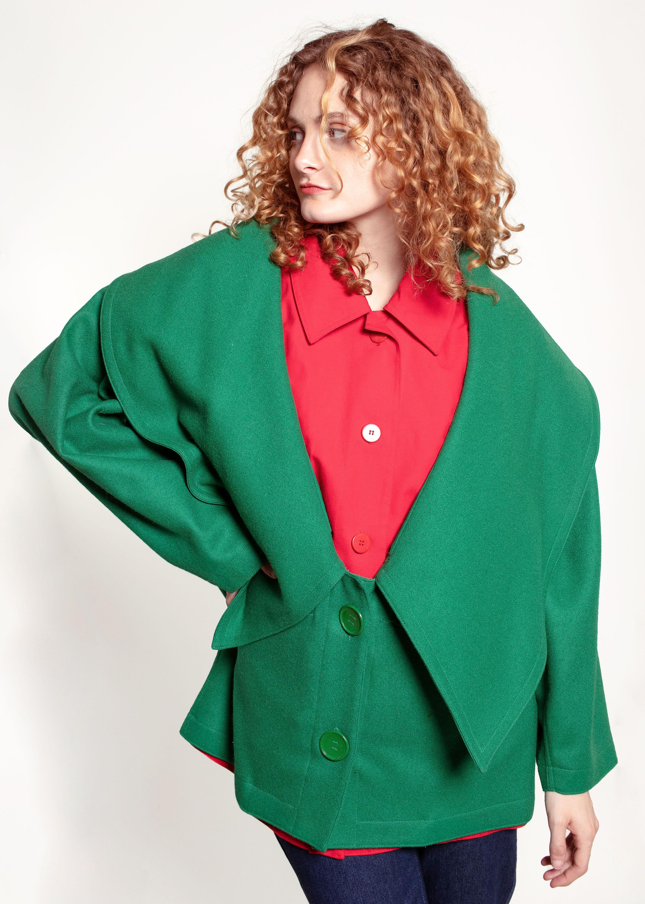 The biggest collar you ever did see! This JC De Castelbajac coat has the look of two layers with the simplicity of one. Designed with two layers and two front pockets, allowing you to stay warm in style. The eye-catching red & green palette is sure