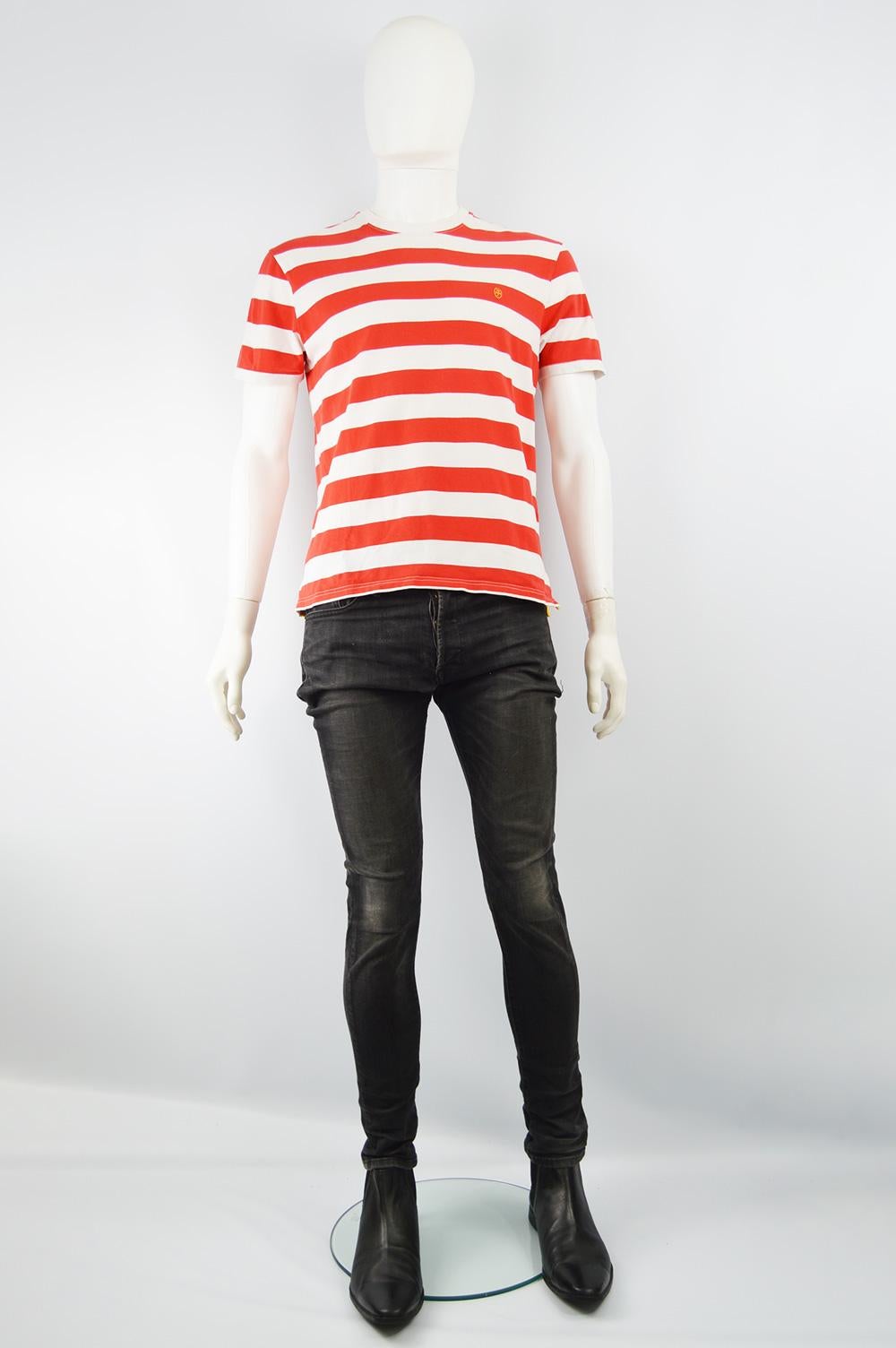 Size: Marked M
Chest - 40” / 101cm
Waist - 38” / 96cm
Length (Shoulder to Hem) - 24” / 61cm
Shoulder to Shoulder - 17” / 43cm
An amazing vintage tshirt by iconic French fashion designer, JC de Castelbajac. In a white and red nautical striped stretch
