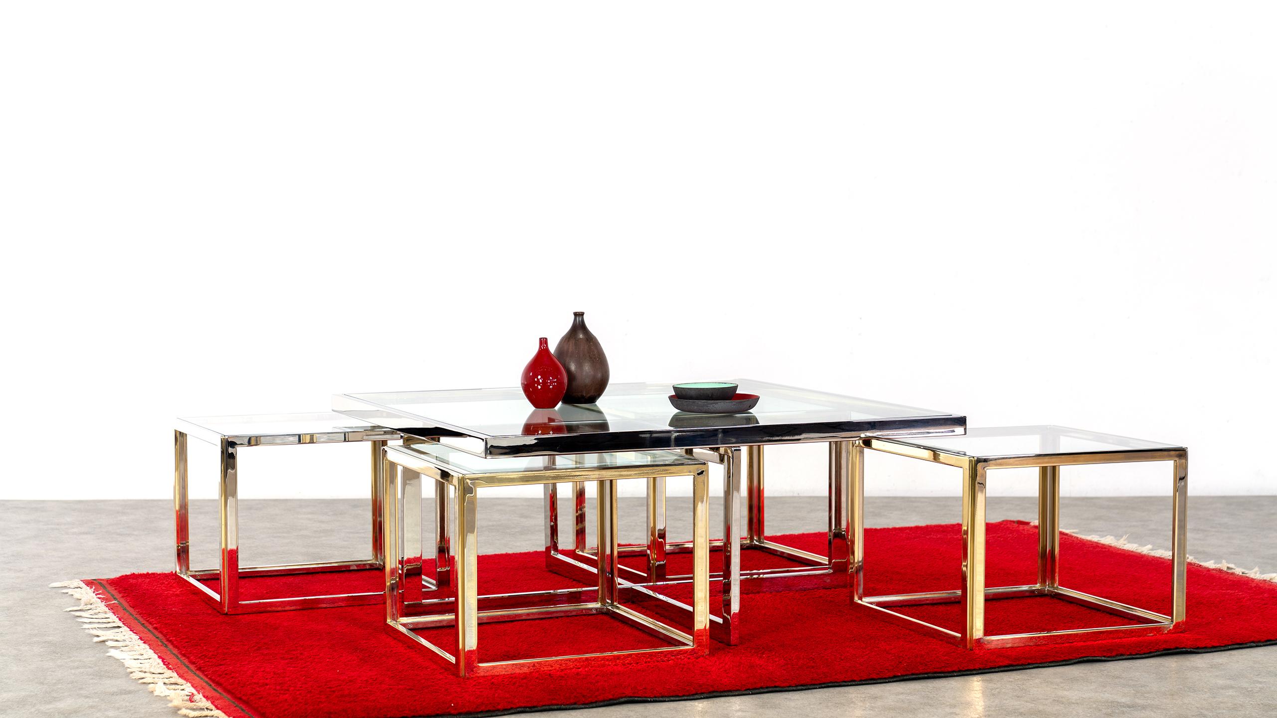 Elegant chrome and glass coffee table with four nesting tables in brass and chrome, designed by Jean Charles, made by Maison Charles.
This set is extremely rare and a real eyecatcher for your interior and for every reception!

The tables are in