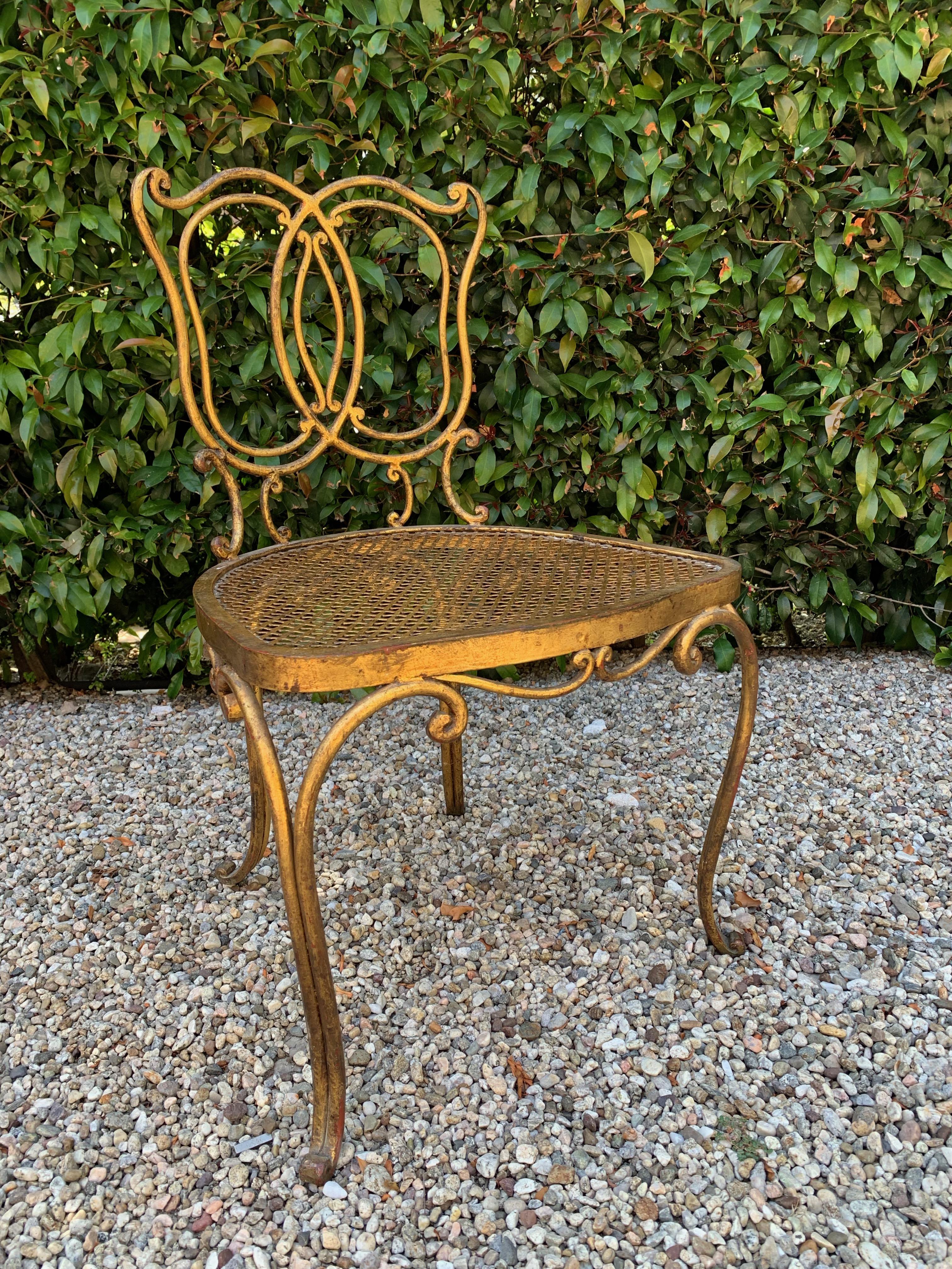 Jean-Charles Moreux gilt French vanity stool chair, a sexy French, petite chair in gilt iron, perfect for the dressing room, bedroom or vanity. With a leopard or solid white, or bone cushion the piece would a comfortable personality all its own.