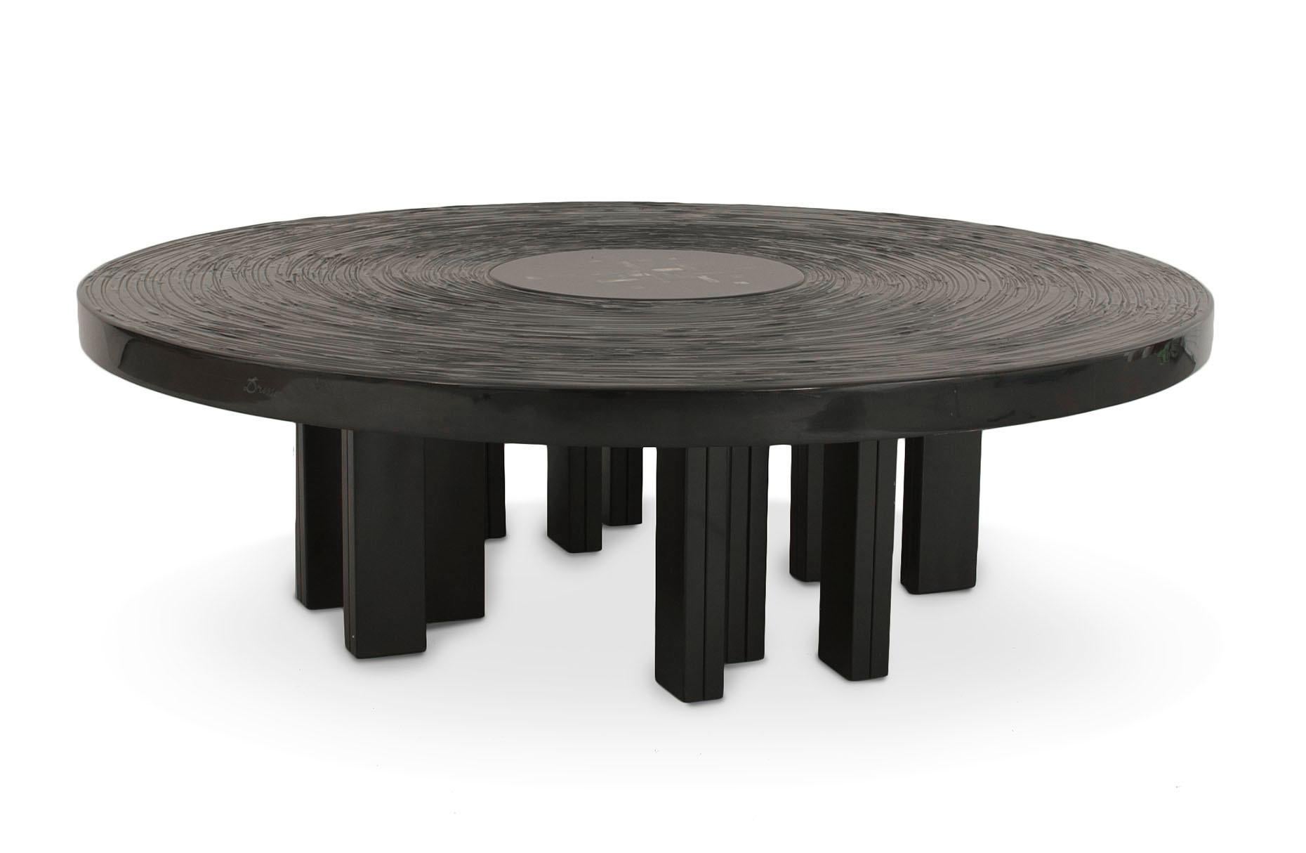 Belgian Modern design round coffee table with black lacquered resin finish and a central mosaic design on a multi-legged black metal base. (by JEAN-CLAUDE DRESSE, signed Dresse '76).
    