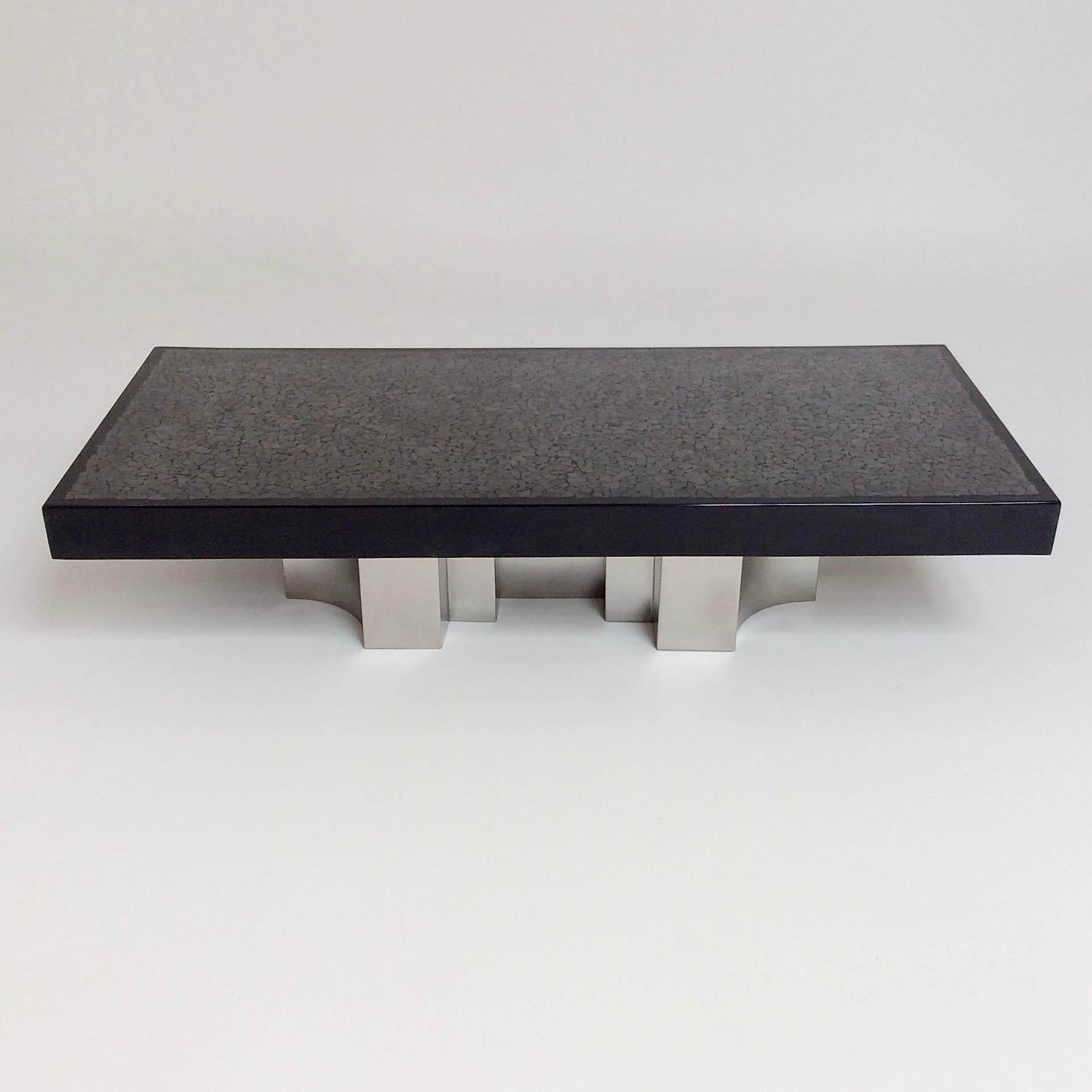 Rare and beautiful coffee table by Jean Claude Dresse, circa 1970, Belgium.
Black resin inlaid of grey/silver hematites.
Signed Dresse on the top.
Sculptural brushed steel base.
Large dimensions: 160 cm W, 70 cm D, 33 cm H.
Good original