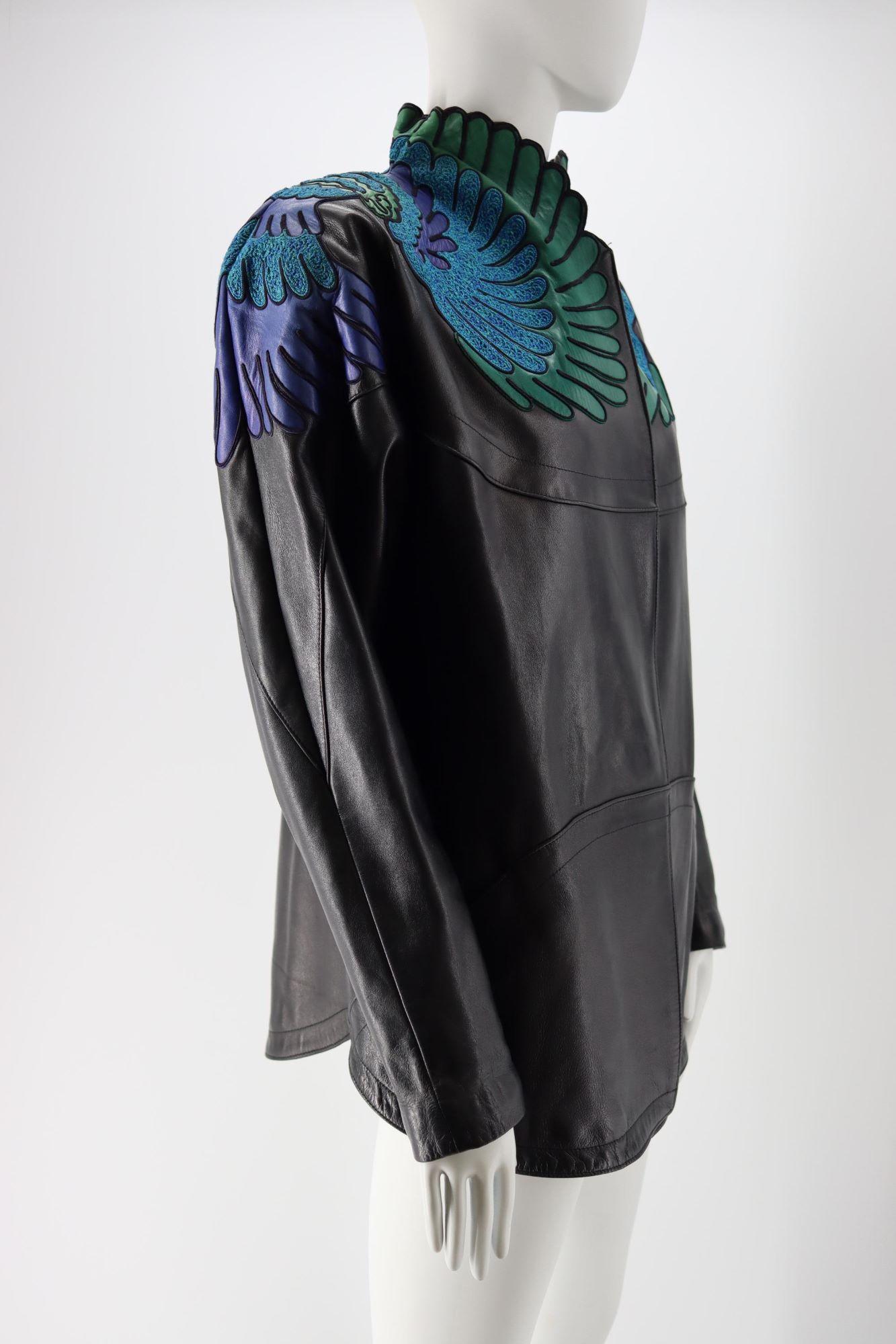 - Jean Claude Jitrois Leather Jacket
- Two pockets at the front
- Floral-esque embroideries in blue with purple, gree and blue leather
- Lining 100% acetate
- Logo embroidered at the back in blue
- Raglan sleeves
- Good condition, shows some light