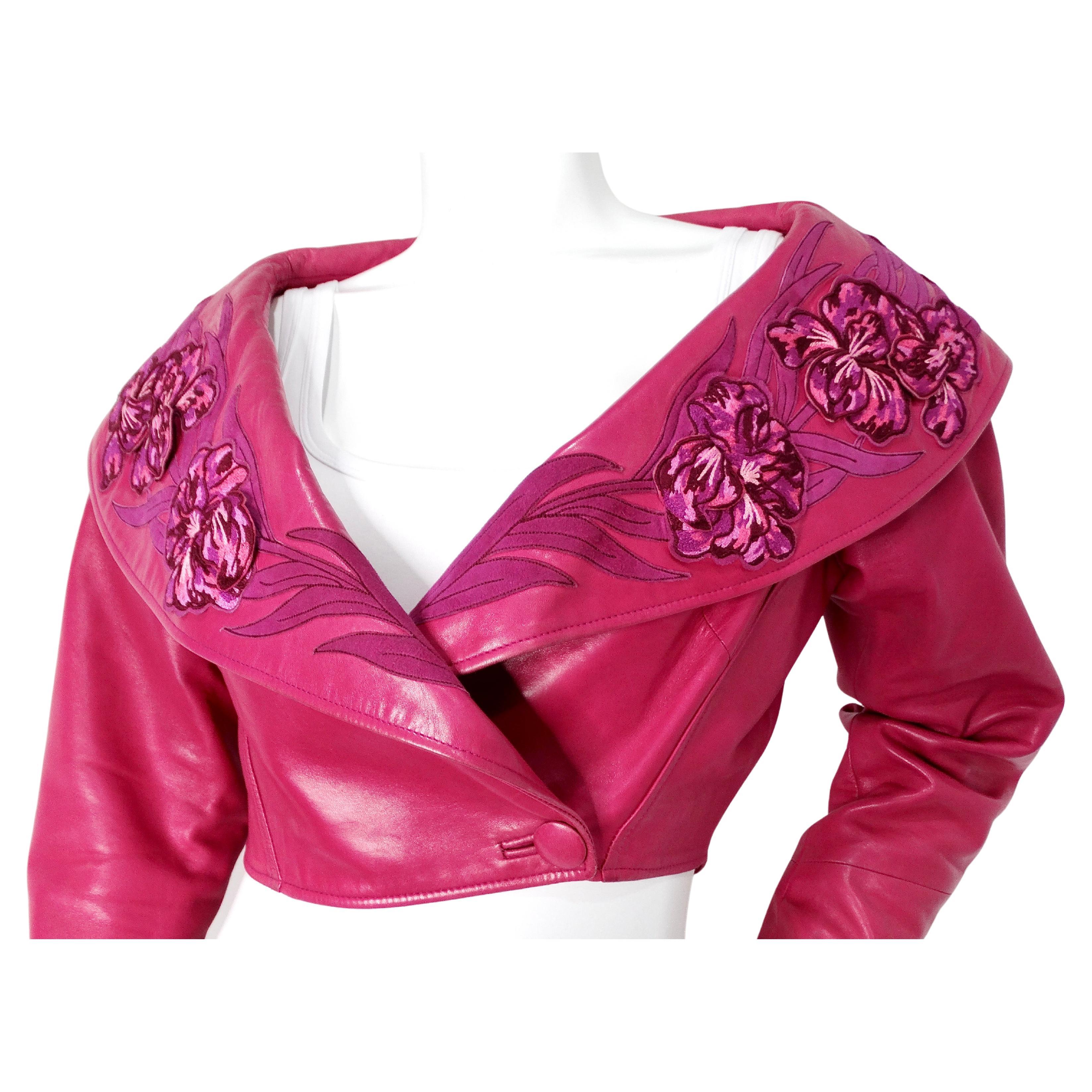 The 1 of 1 custom made #15179 Jean Claude Jitrois Fuchsia Floral Leather Cropped Jacket from the circa 1990s is a striking piece that exemplifies bold, avant-garde fashion of the era. Crafted from luxurious leather, the jacket features an