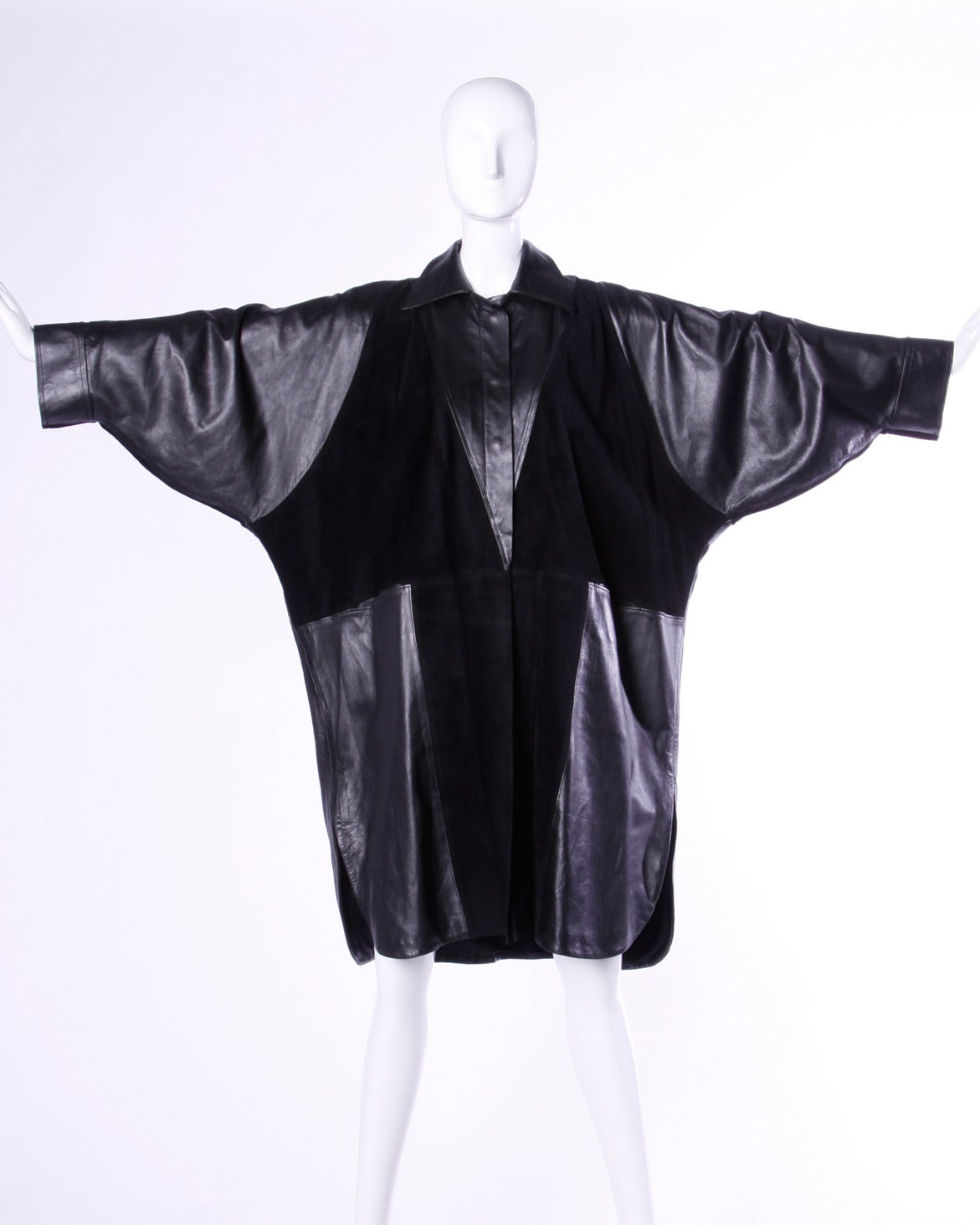 Stunning avant garde batwing coat by Jean Claude Jitrois featuring sued and leather fabric blocking, huge dolman sleeves and an elegant and unique silhouette. Soft buttery leather and unparalleled quality, this coat is just beautiful in