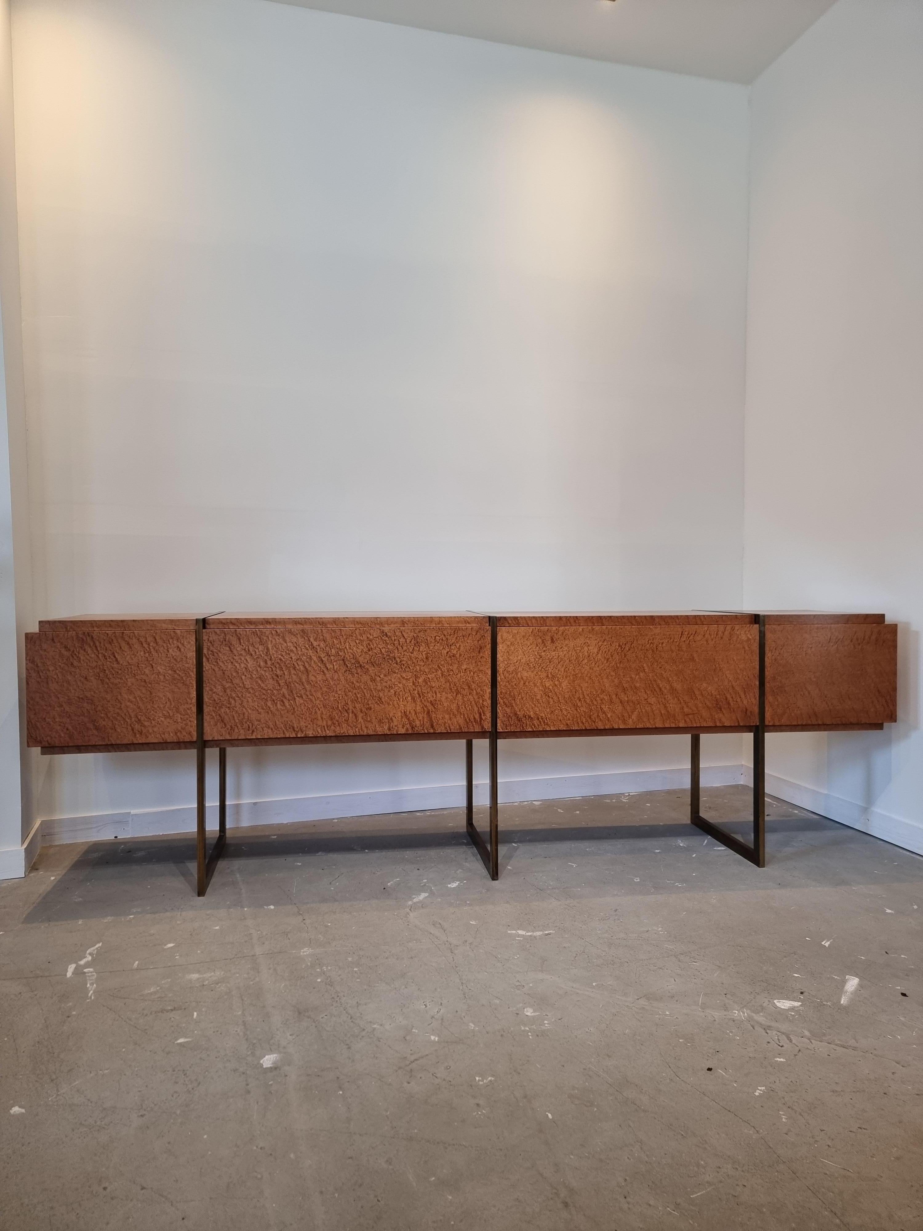 Beautiful sideboard or credenza in Olive burl wood veneer with 3 slim brass base legs by Jean Claude Mahey.
The piece is a beautiful Mid-Century Modern / 1970s 
In style of Milo Baughman for Thayer Coggin. 
A very big, long piece!
4 burlwood