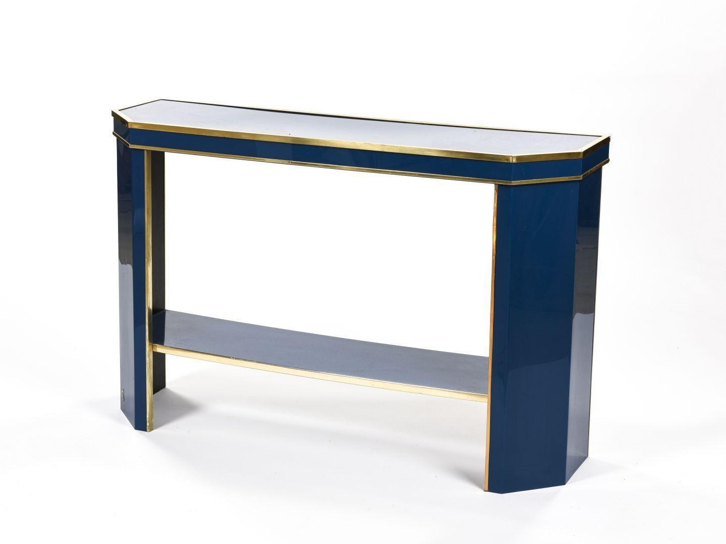 Jean Claude Mahey, French artist born in 1944. 

Console with double shelves in blue lacquer with gilt brass frame.
circa 1975
Monogrammed 
Measures: Height 78 cm, length 121 cm, depth 36 cm

Good condition.