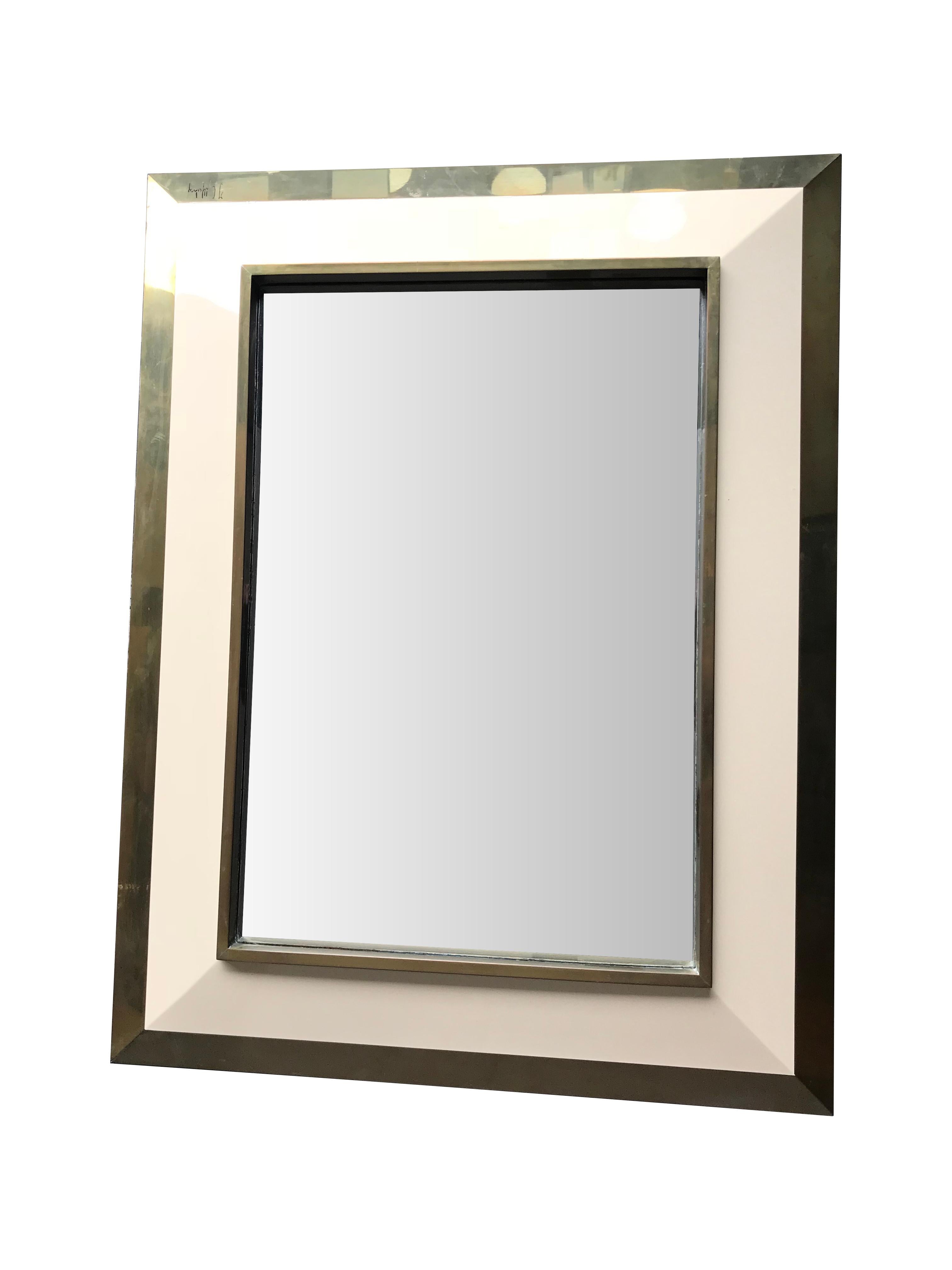 A Jean Claude Mahey mirror with angled raised ivory lacquer and brass convex frame surround, signed on the bottom right hand corner 