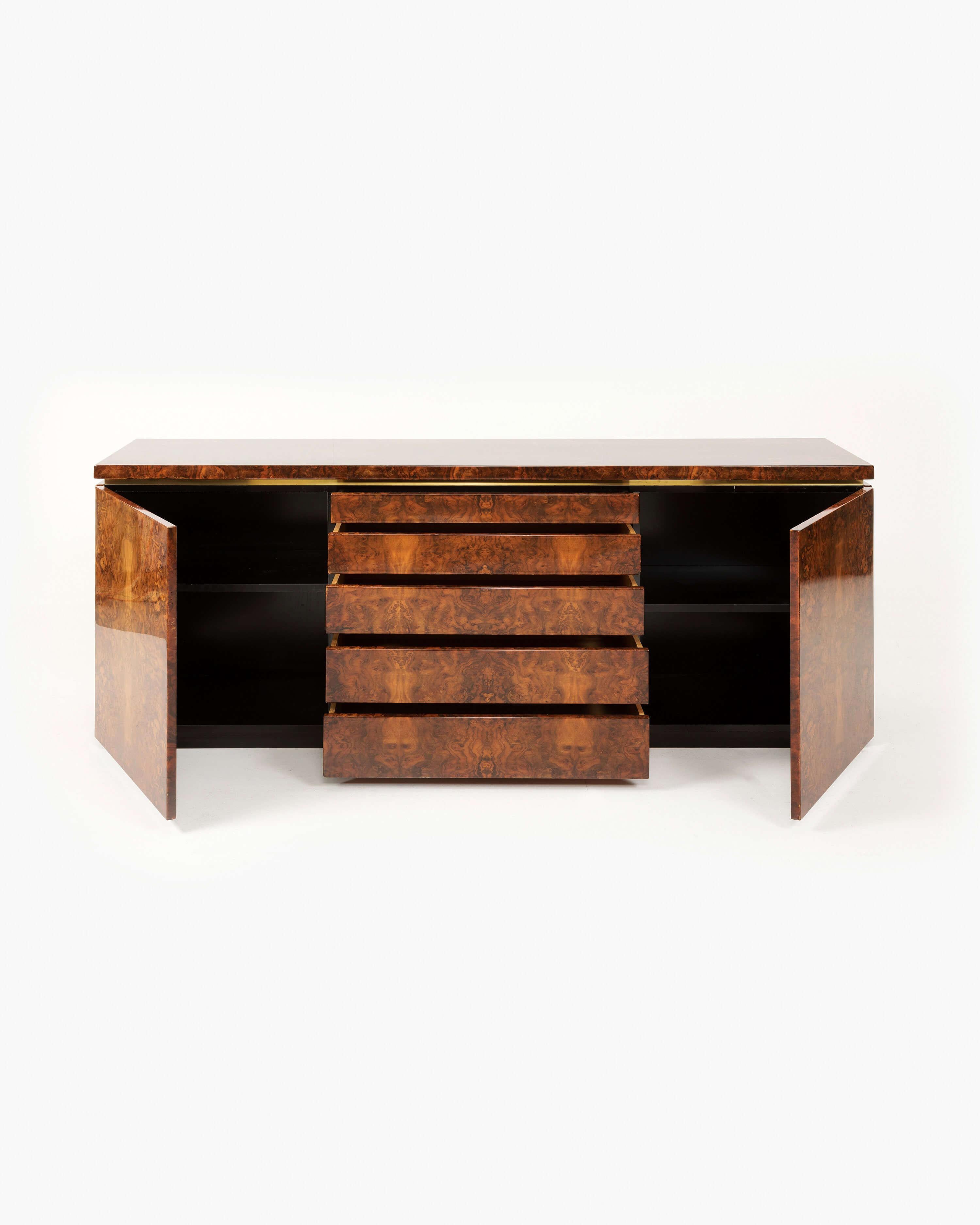 This lacquered burl sideboard by French designer Jean-Claude Mahey boasts a distinguished gilded profile that reflects the designer’s affinity for the finest materials. Born in the northwestern French city of Mayenne—a region populated by small