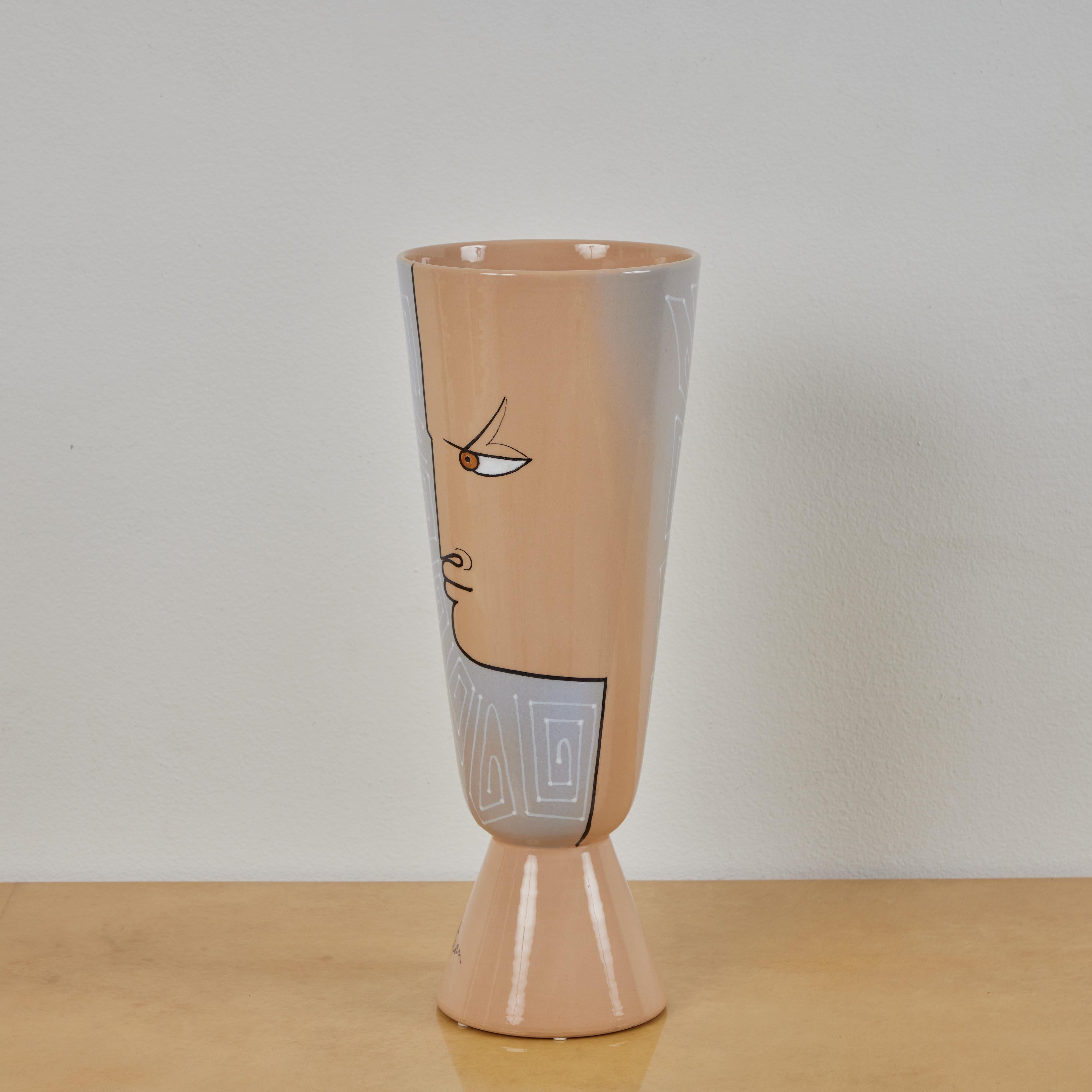 This is a glazed earthenware vase produced by Roche Bobois in the 2010s. The vase utilizes a design Jean Cocteau produced in the early 1960s. It features 2 taupe profiles with geometric details over gray. The taupe and the grey blend nicely. This is