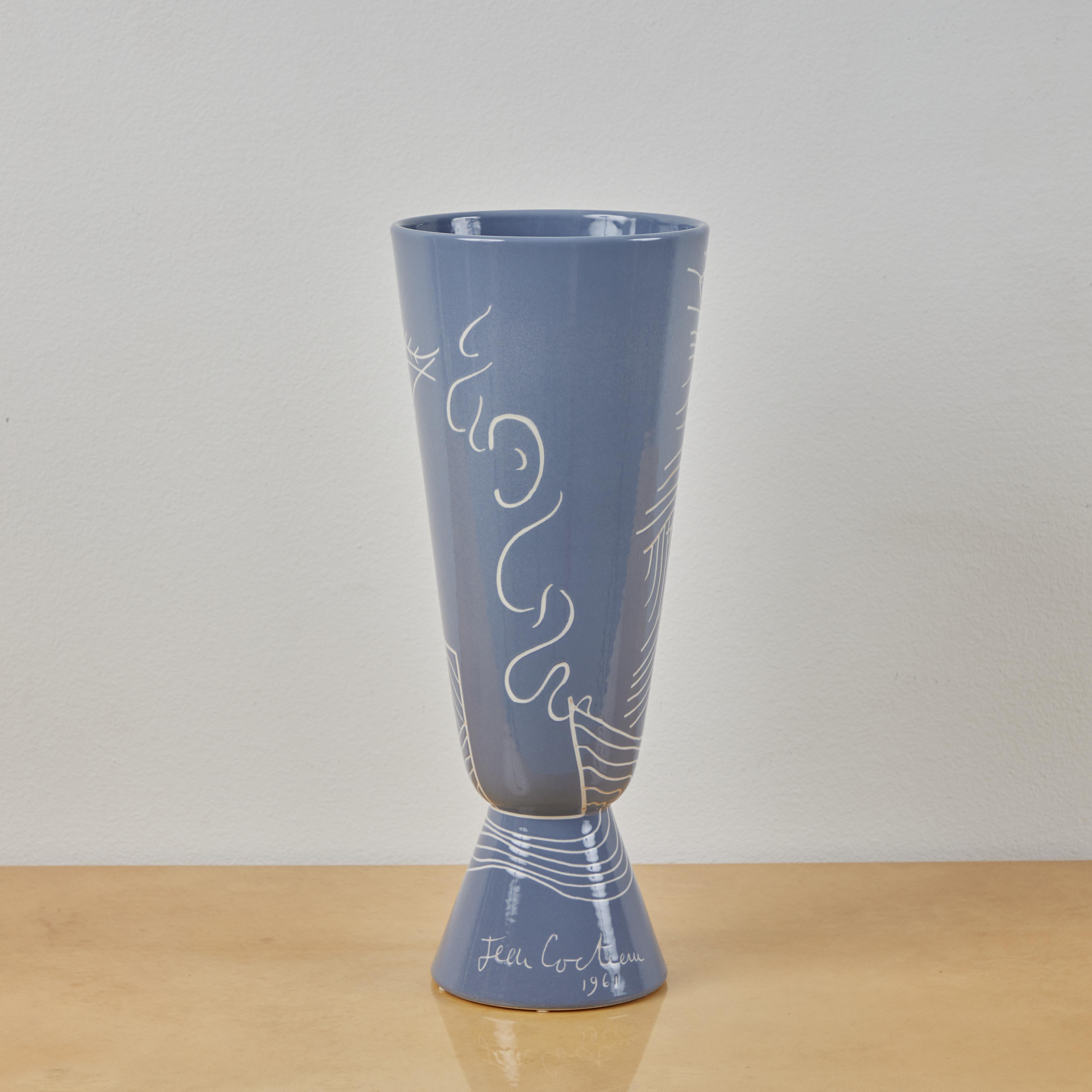 This is a glazed porcelain vase produced by Roche Bobois in the 2010s. The vase utilizes a design Jean Cocteau produced in the early 1960s. its signature design features a profile, fish, and geometric design. From a limited edition of 1,000 produced