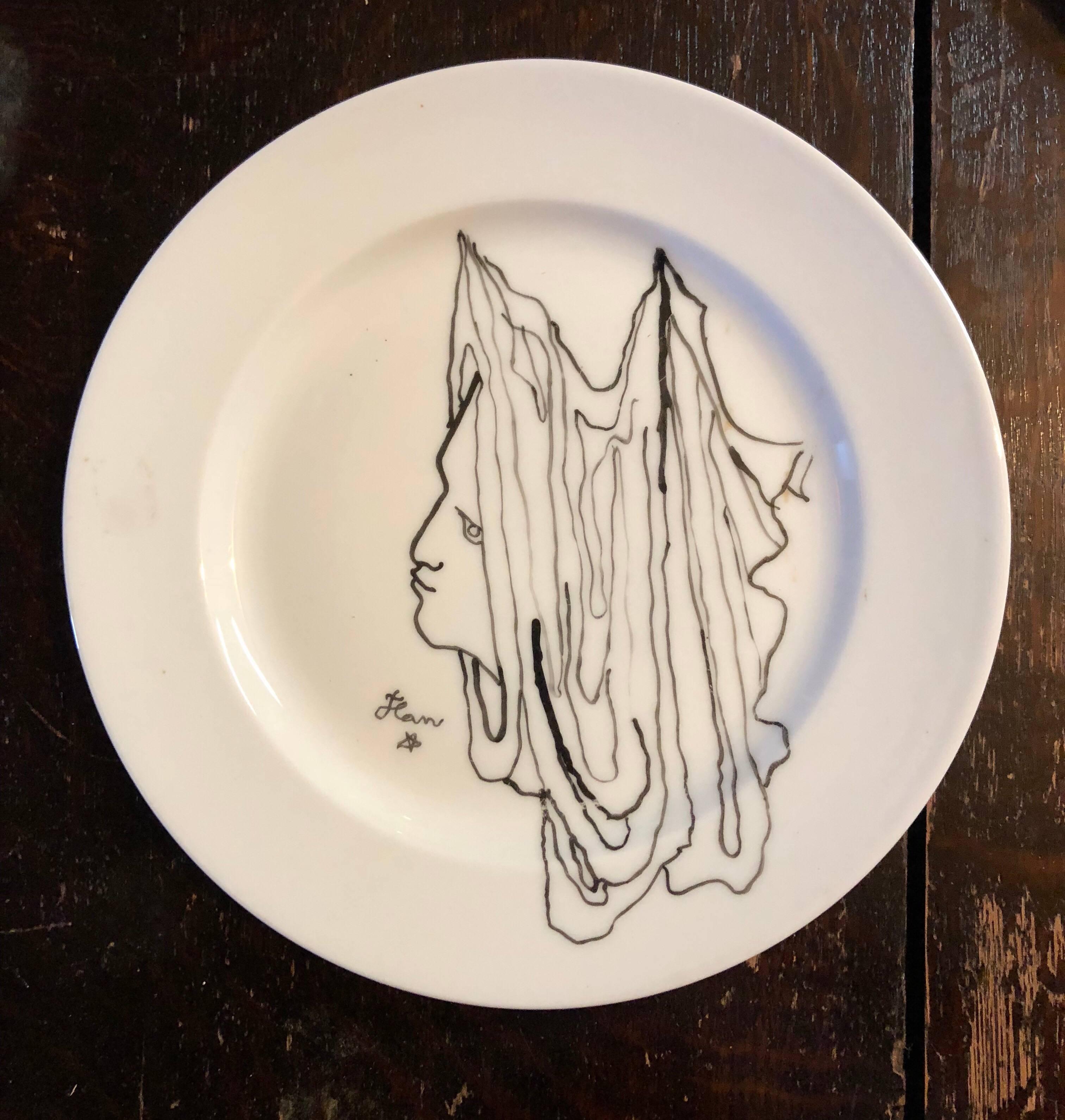 Signed Edite par Christofle. They also did artist plate collaborations with Gio Ponti and Man Ray. Cocteay also did some with Limoges, France. This is just signed Jean with his trademark star.  Jean Maurice Eugène Clément Cocteau (French, 1889 –