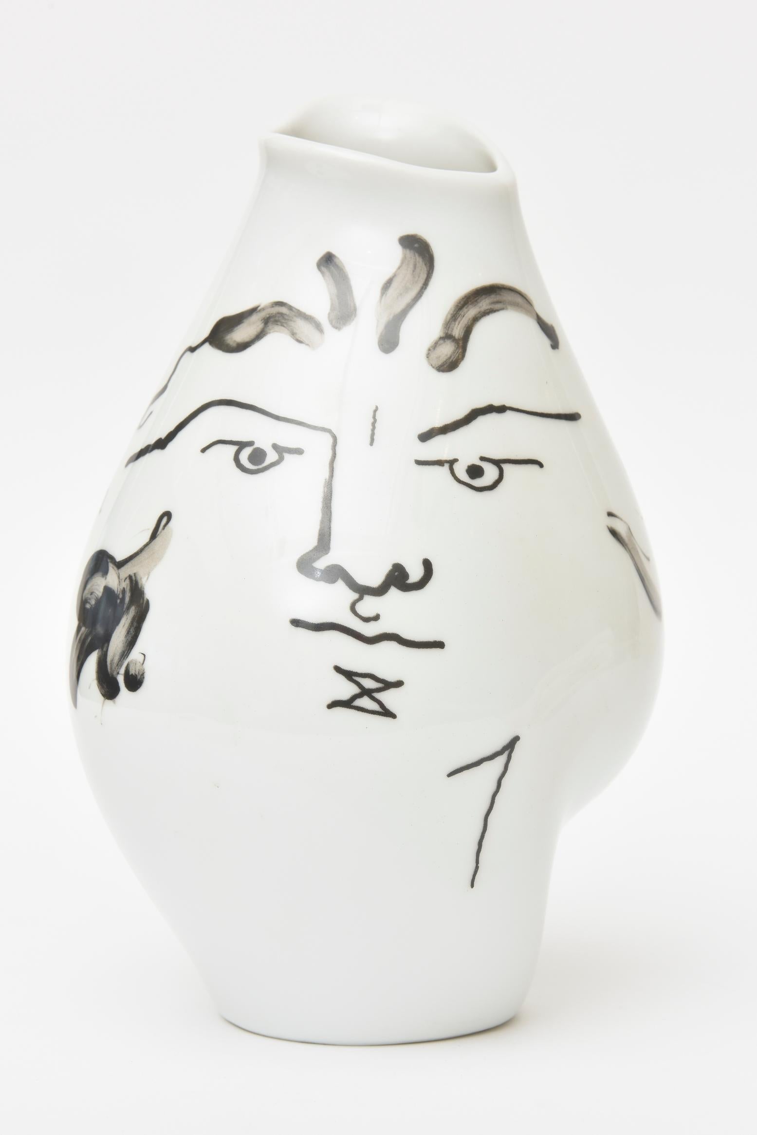 This wonderful glazed porcelain tetes face vase originally designed in 1952 by Jean Cocteau and was produced in the early 1970s by the Classic Rose Rosenthal Group, Germany. The freeform design of abstract facial motifs and ovoid irregular shape of