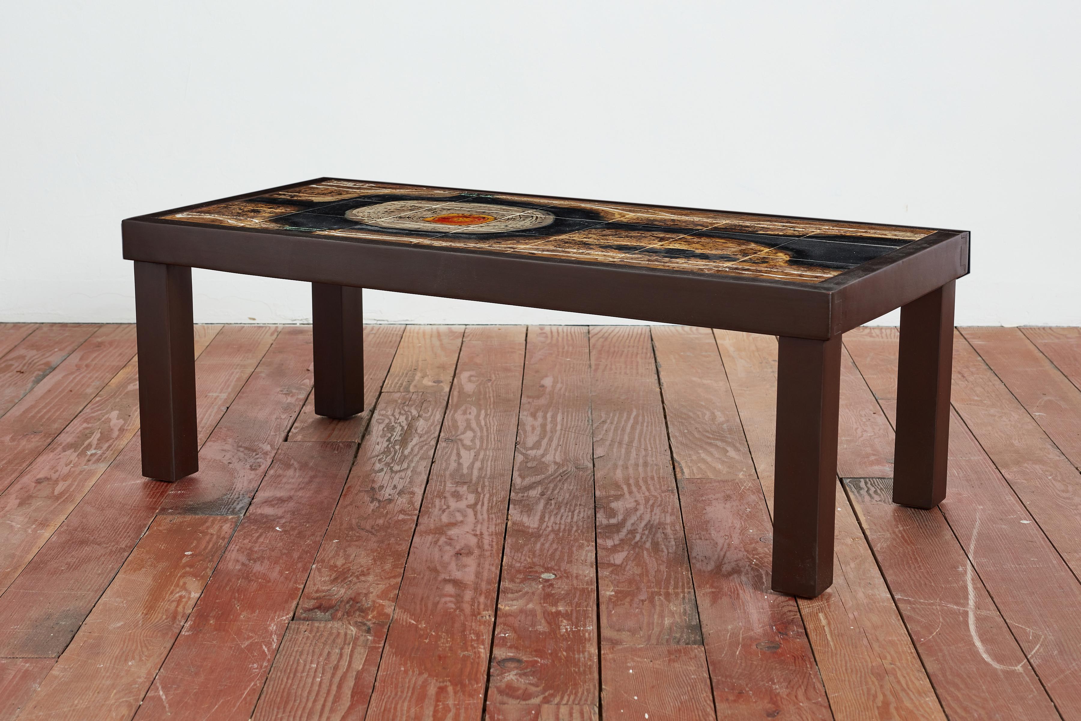 Wonderful coffee table by Jean d'Asti with ceramic tiles from Vallauris, France circa 1960's. Frame in elm wood that is newly refinished. Rich natural colors of ceramic with rich bright pop of color

Signature on tile. 

France, 1960s.