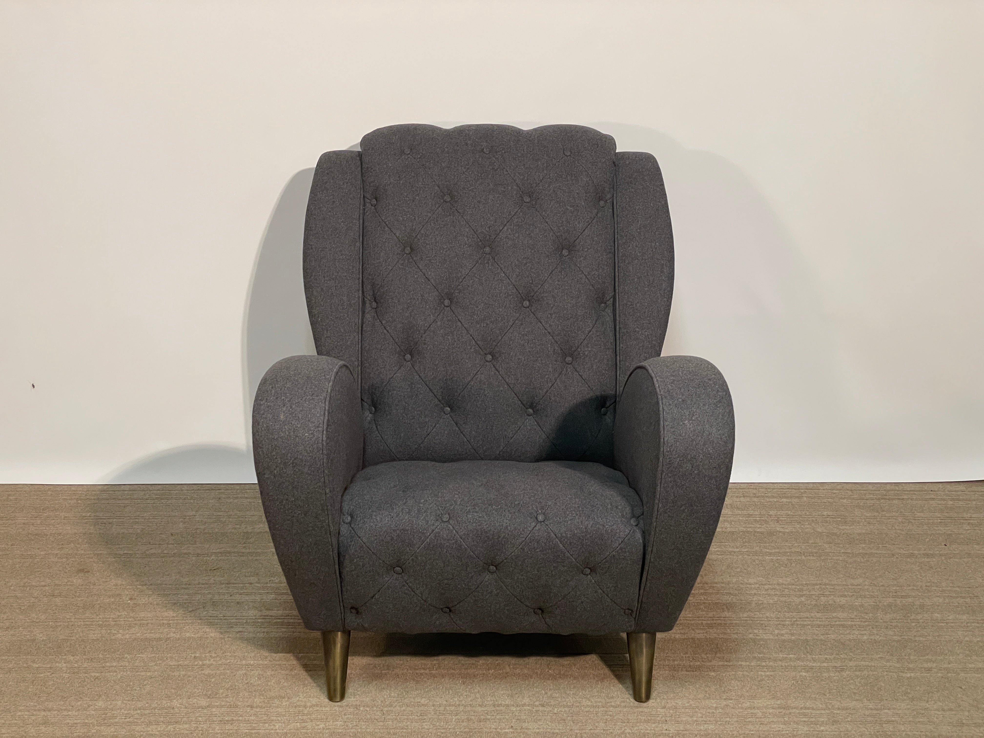 Jean de Merry's Andre arm chair is a subtle nod to the atomic Googie era merged with classic design style.  The body of this chair hovers above the ground supported by bronze MCM style legs finished in Antique Bronze.  The fabric is in excellent