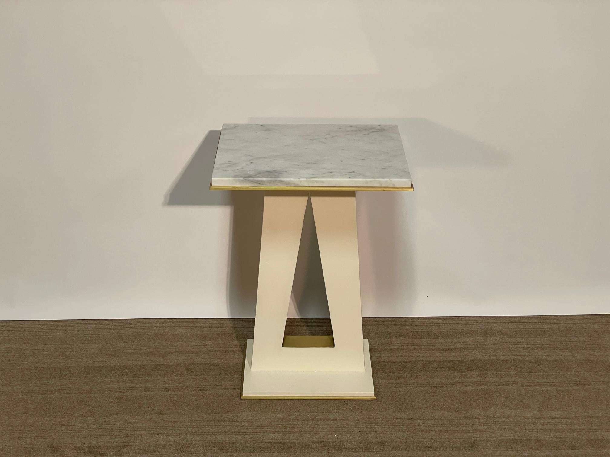 Jean de Merry's Api side table is composed of a wood frame with marble top and bronze accents on the base and top and inlay through the center design.  The frame is finished in Liso Satin and the bronze in JDM's Light Bronze.  Both tables are