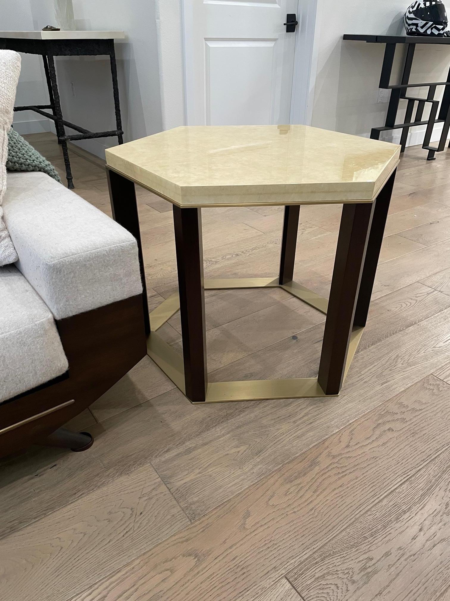 Jean de Merry's Uros side table works elegantly as a traditional side table, corner table, or accent table.  The timeless mixture of Wood, Bronze, and Papyrus French Lacquer finish blend well with traditional and transitional decor.  The shape of