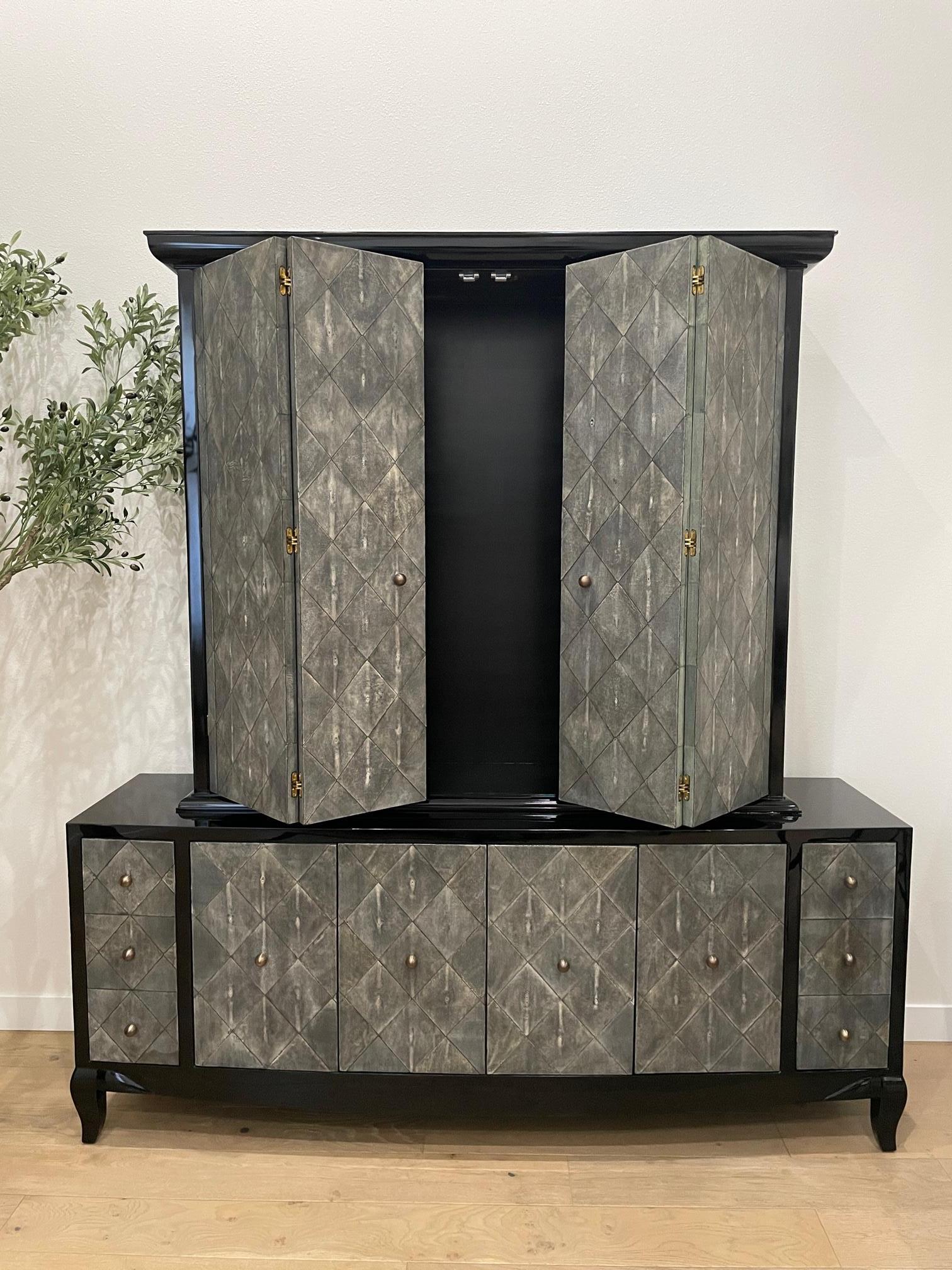 Jean de Merry's Viala cabinet is meant as an intimidating and impactful statement piece for a regal dining room or living room setting.  Standing over seven and a half feet tall, the dark and moody piece shimmers with its hand-laid Ebony French