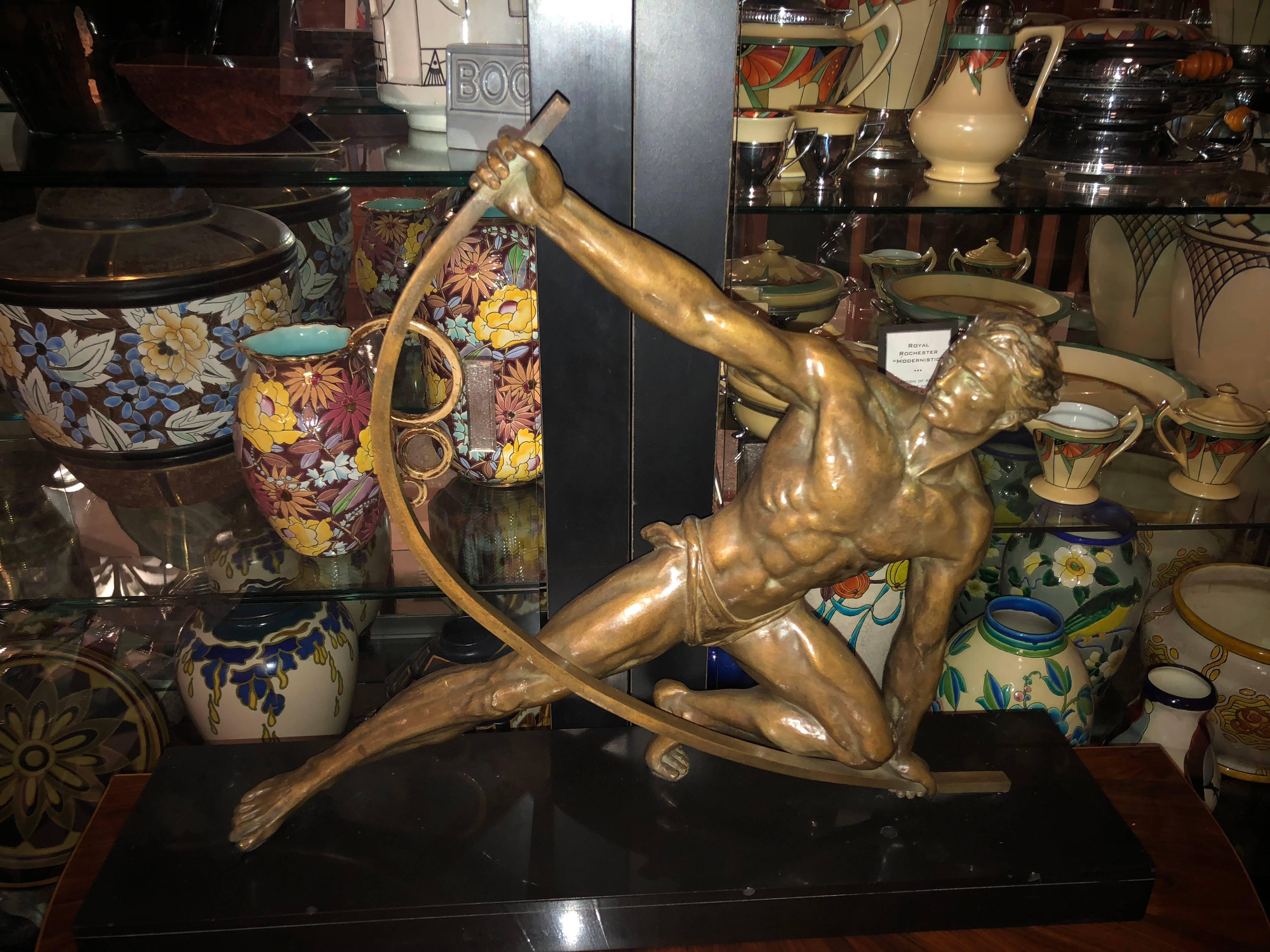 This dramatic Art Deco sculpture by the “master” of masculine and athletic figures in the 1920s and 1930s, Jean De Roncourt, a rare original brwoze version of this piece. Entitled Le Bendeur (or, in English, The Bender), it depicts an athletic man