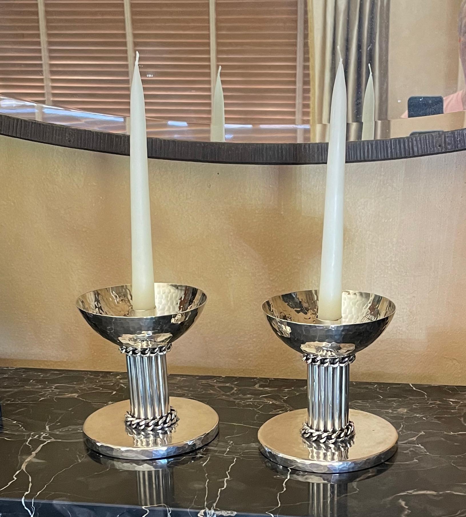 Jean Despres important French designer, known for original jewelry designs, champagne buckets, cocktail shakers, and many fine objects of art. This spectacular pair of heavy candlesticks with a hand signature on the bottom of each candlestick, sign