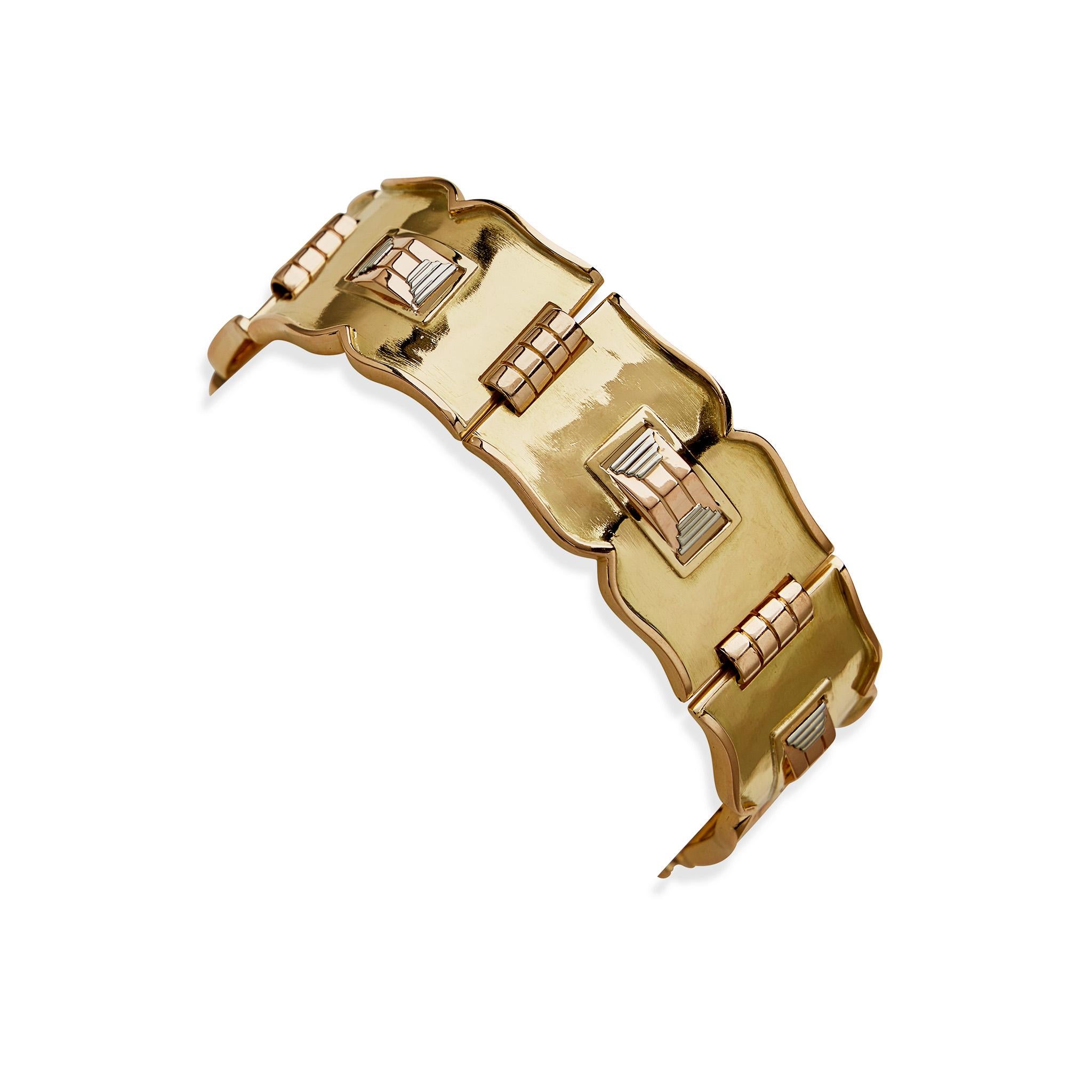 Composed of tri-color 18K gold, this modernist bracelet by French jewelry artist Després dates from 1935-1940. It is designed as a series of yellow gold arched, waisted plaques with subtle hammered texturing, centering ridged prism and graduating