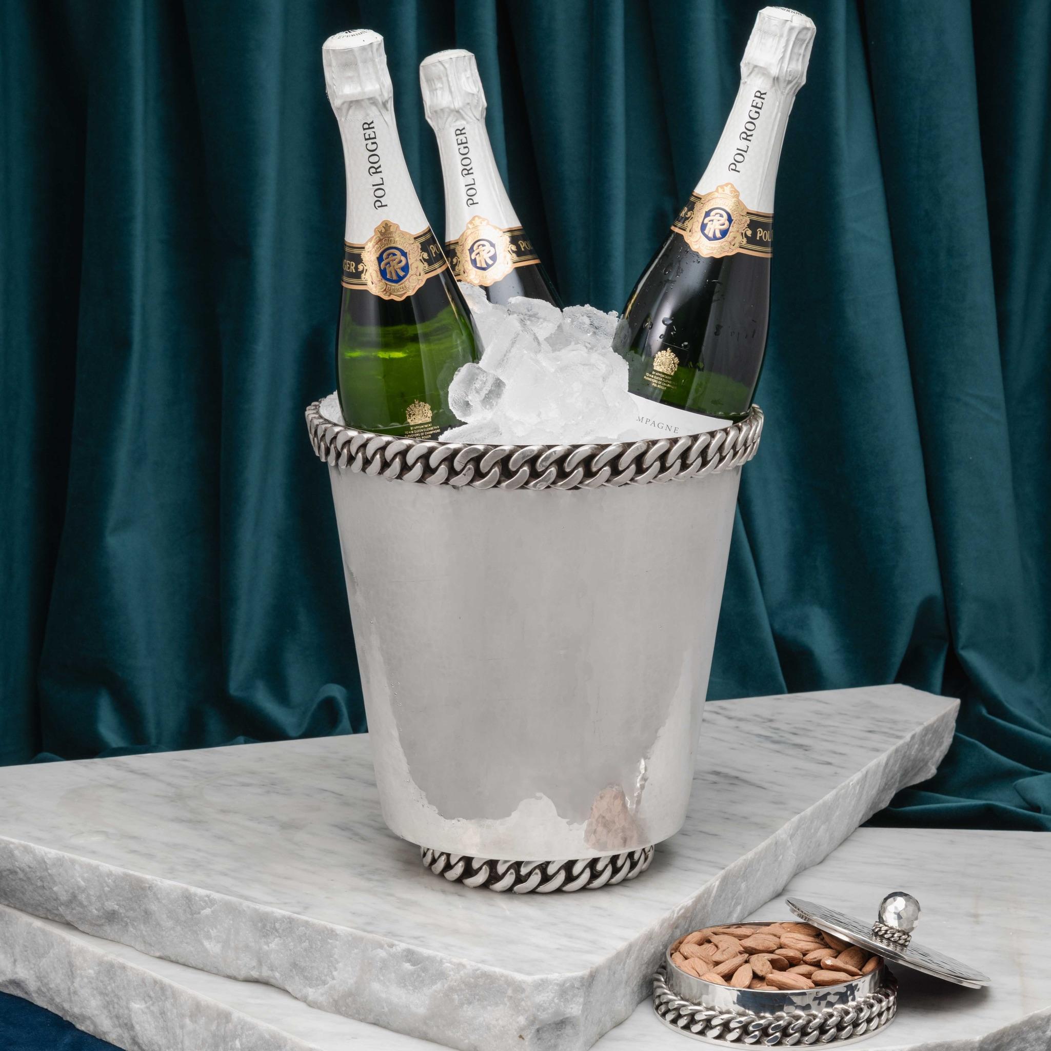A superb large silver plated Champagne bucket/wine cooler of excellent quality with maker's mark for the French 'Art Moderne' designer Jean Després, featuring his signature 'Gourmette' chainlink decoration.

This weighty silver plated ice bucket is