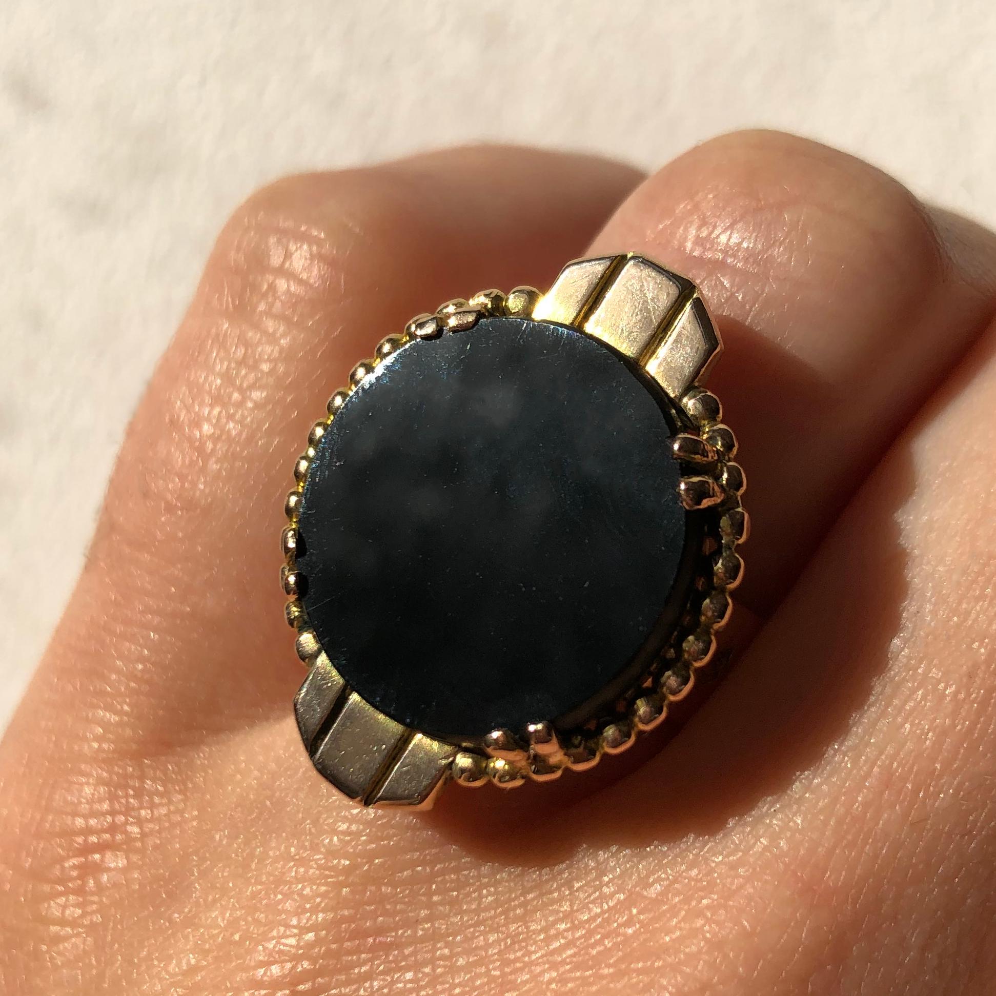 An onyx and 18 karat gold ring, by Jean Després. c. 1930 - 1950. 
Signed Jean Després. Stamped with French Assay marks and maker's mark for Jean Després.
Ring size 6.5. This ring can be resized. 
Deprés (1889 - 1980) was an Art Deco, French jeweler