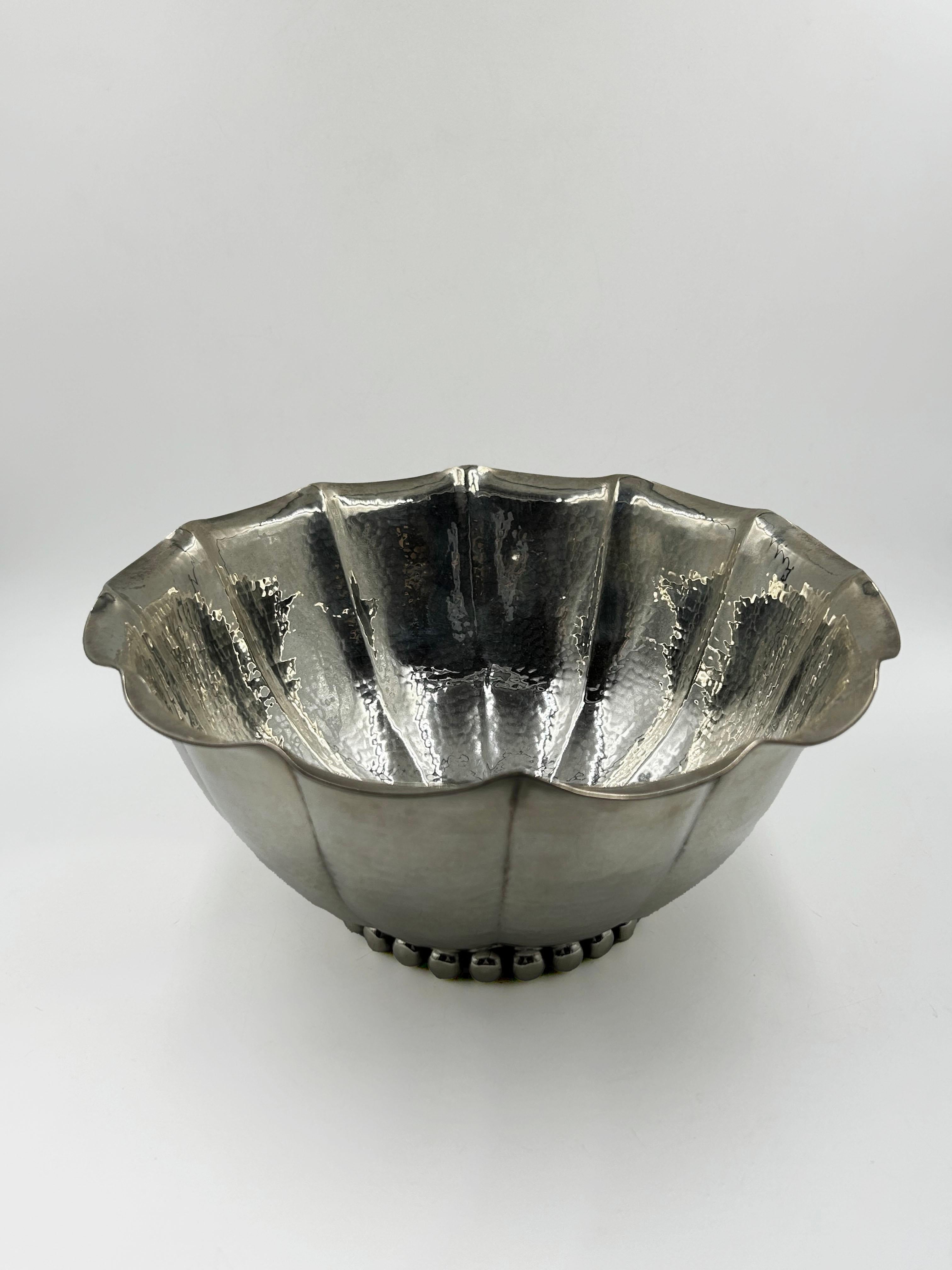 Jean Despres Silver-Plated Centerpiece
This centerpiece is a work by French goldsmith Jean Després, characterized by an Art Deco and Modernist design. The piece is made of silver-plated metal with a completely hand-hammered surface, giving it a
