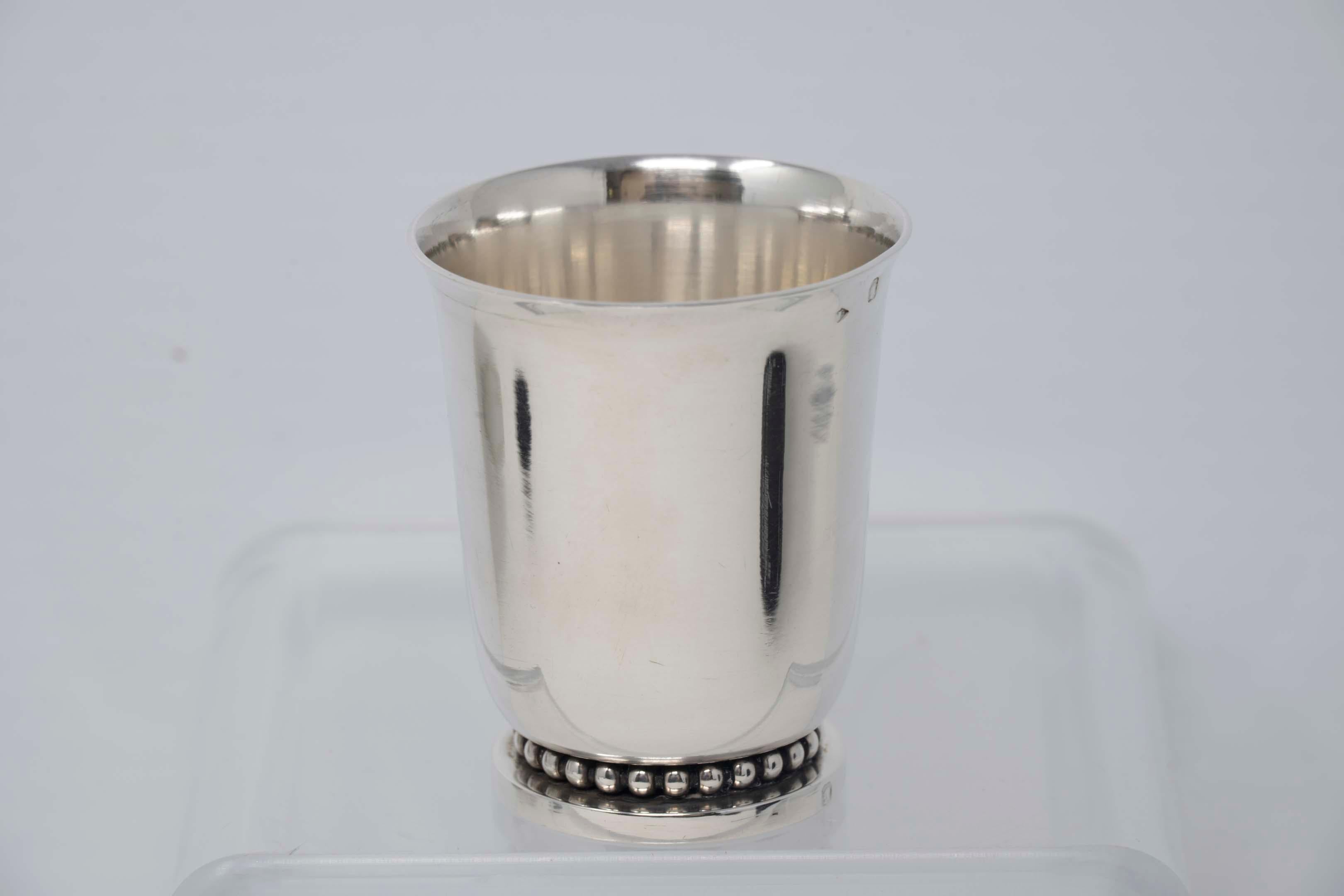 Jean Despres art deco sterling silver beaker. The beaker measures 2 1/2 inches tall. It is signed on the base J. Despres. The maker mark and Minerve mark are on the side. It's in excellent condition.
