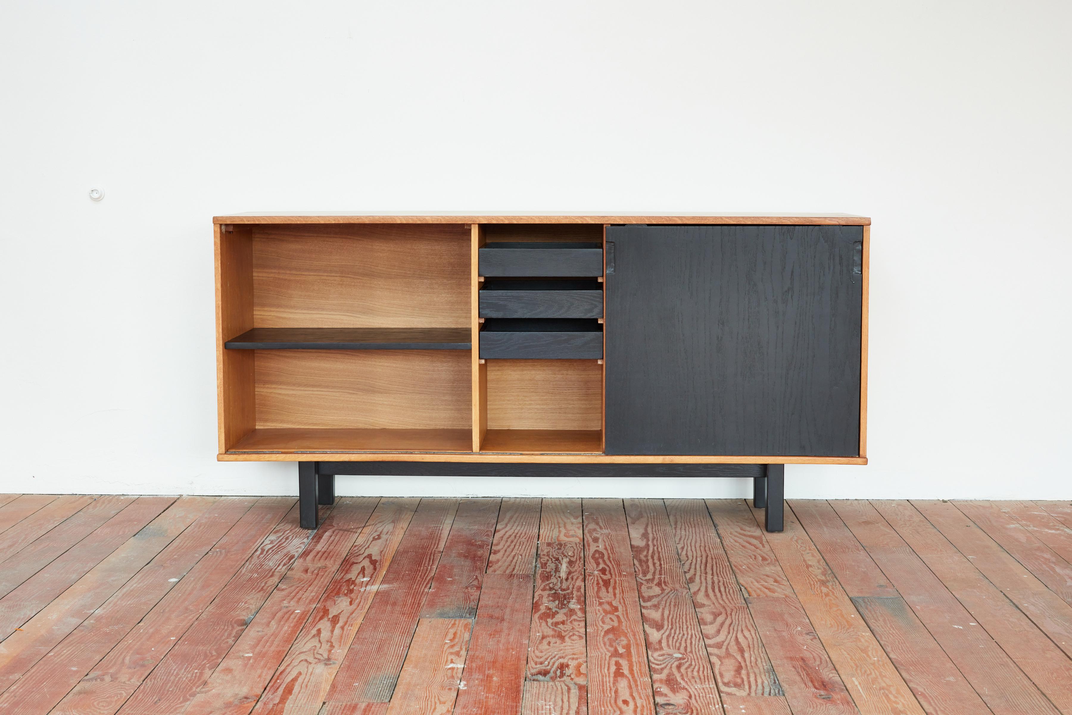 Oak and black sideboard by Jean Domps, circa 1950s.
Created for the 