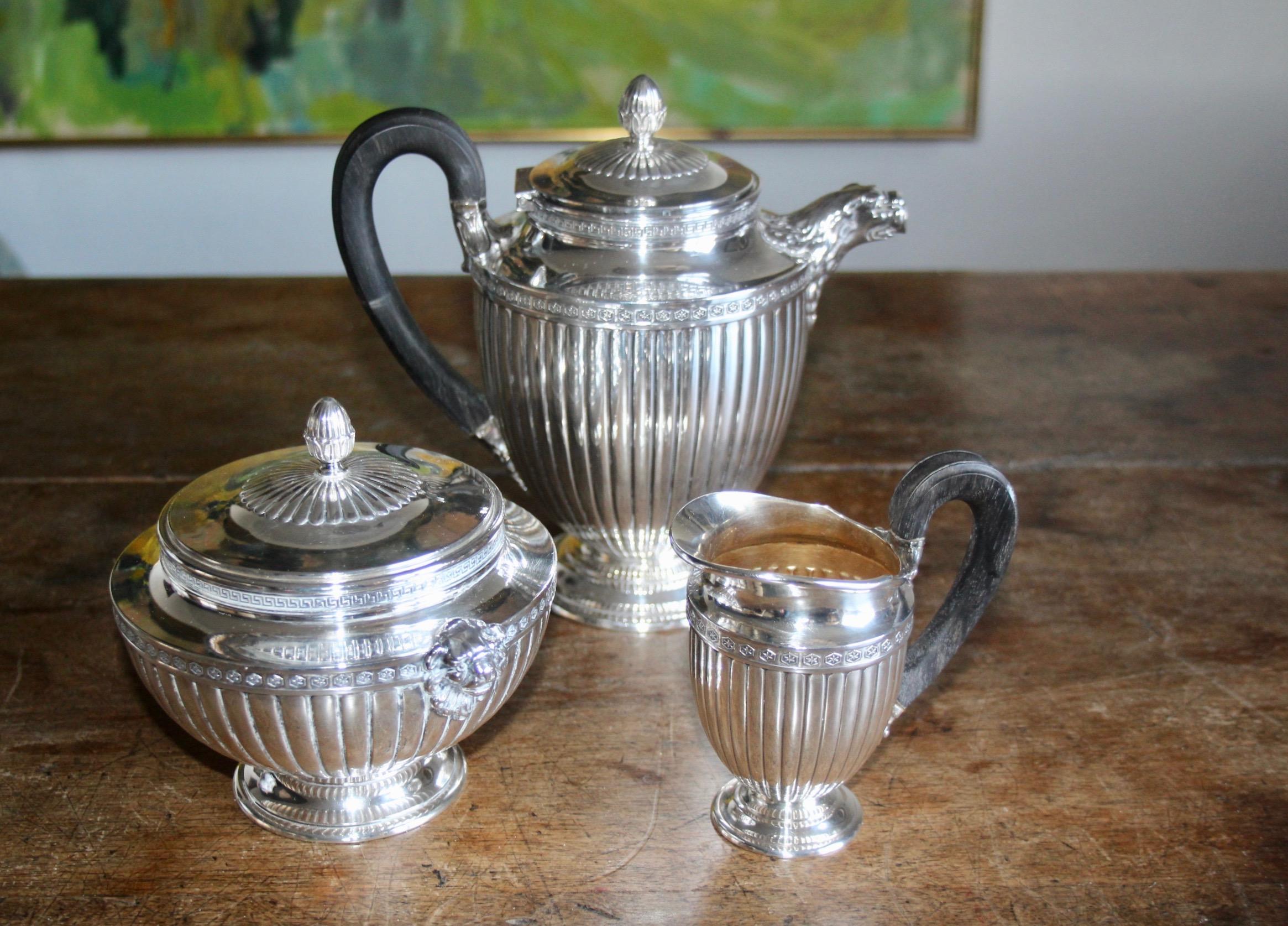 A timeless set for tea and coffee in neoclassical form in silver with wood handle, from the maker Puiforcat Paris, these are a beautiful and timeless set for tea and coffee, consisting of a tea pot, creamer and sugar bowl. Fully hallmarked and also