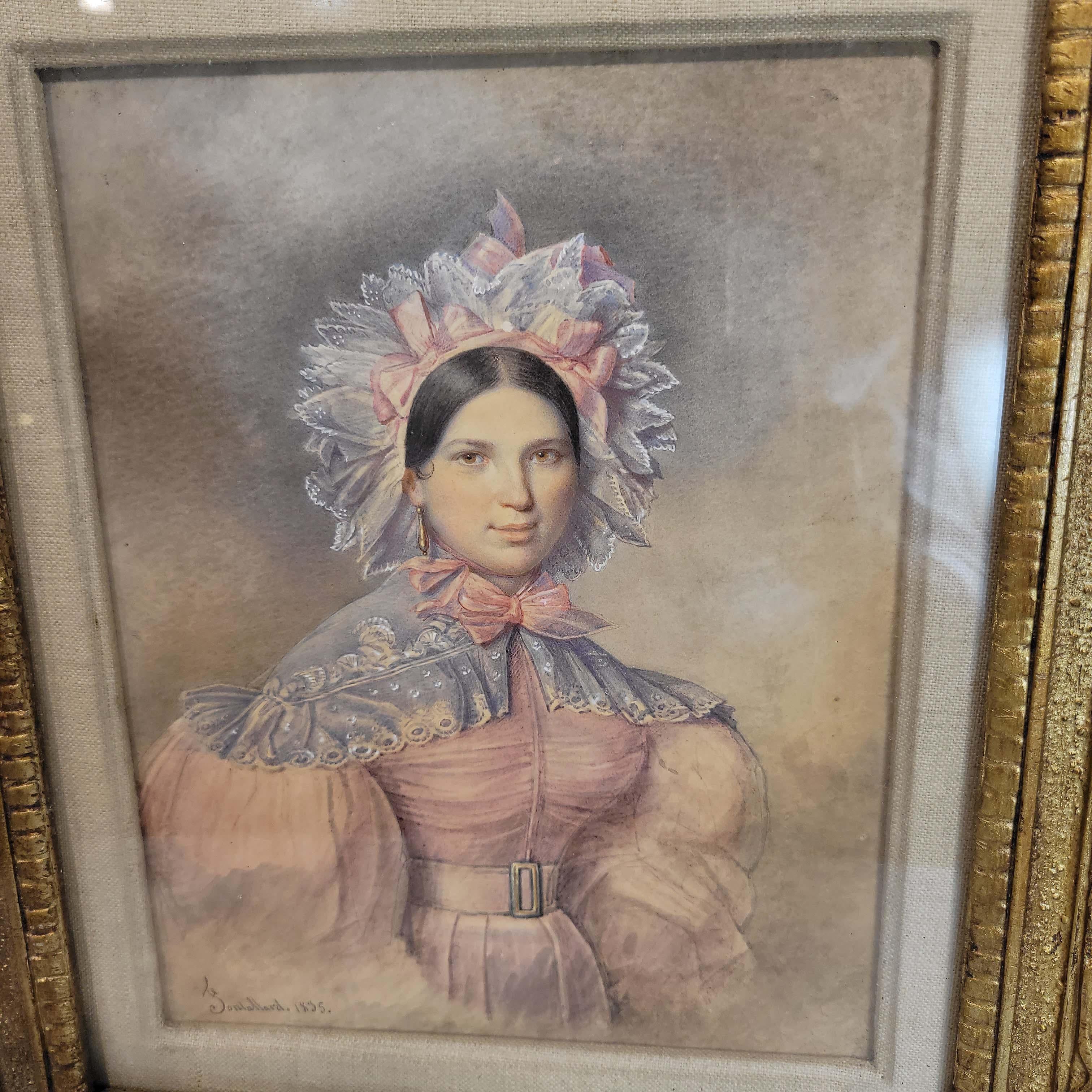 Watercolor and gouache on paper signed and dated 1835. Depicting a young beauty in a pink sild dress with light blue lace collar tied with a pink sheer bow around her neck and sililar color head dress. She is wearing gold earring. Mounted in gilt
