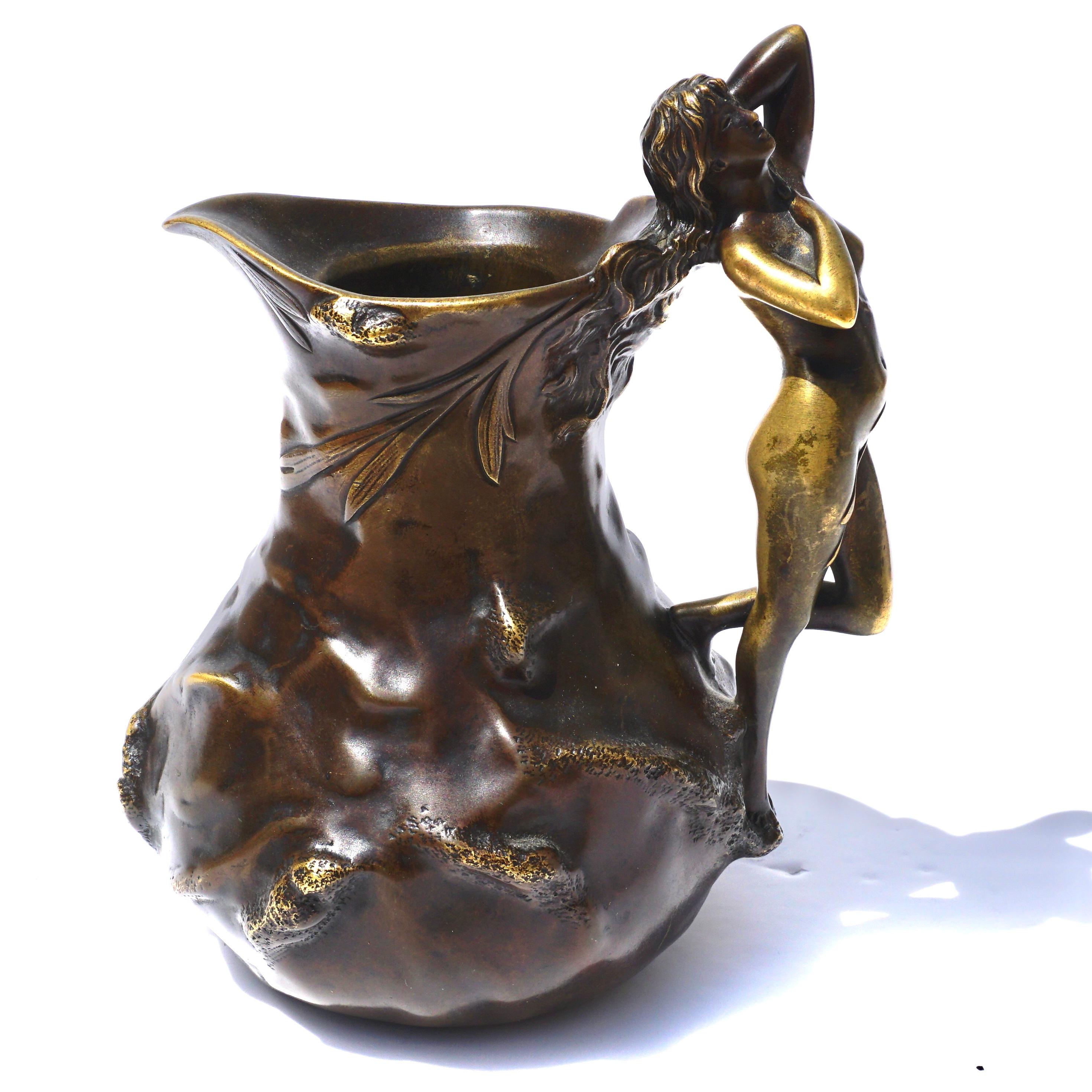 French Art Nouveau Patinated Bronze Figural Jug with a handle form of a nude Art Nouveau maiden with her hands in the submissive position.
Cast by Jean Garnier, circa 1900
Inscribed “J. Garnier”, 

Height 7 inches
Width:6 Inches

C Estate of