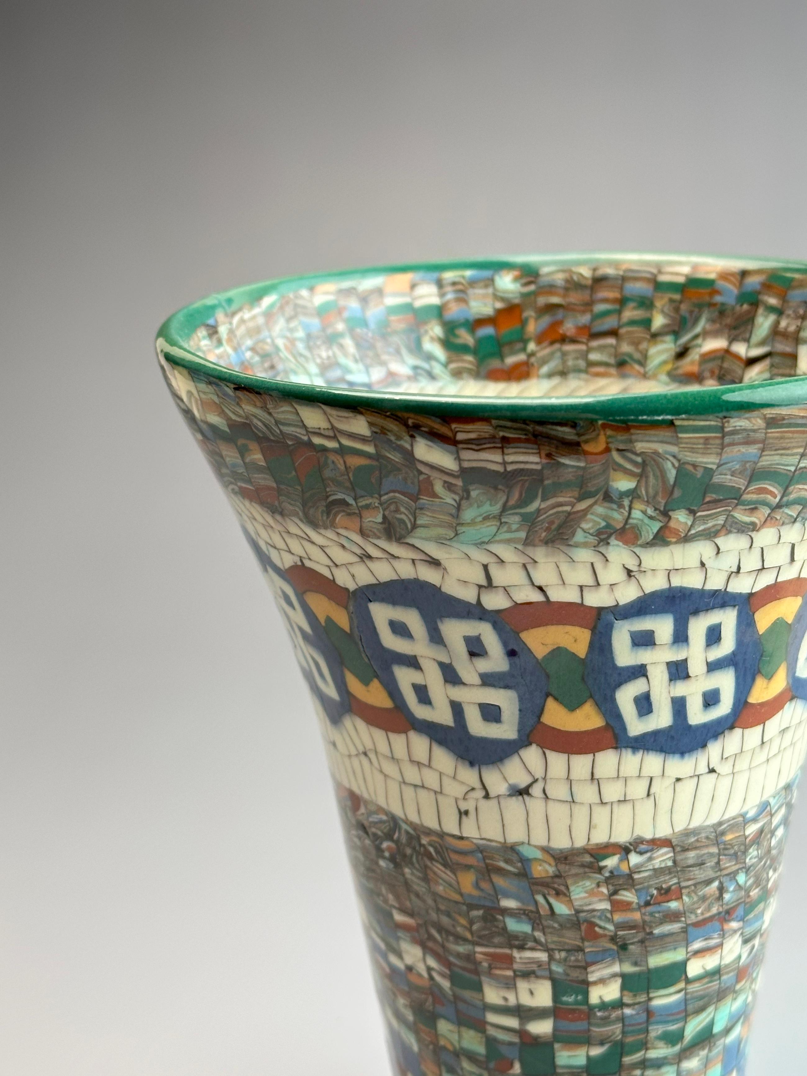 An exceptional Art Deco ceramic trumpet vase by Jean Gerbino, crafted in Vallauris, France, circa 1930s. Known for his pioneering approach to neriage ceramics, Gerbino developed a distinct process that combined coloured clays into precise mosaic