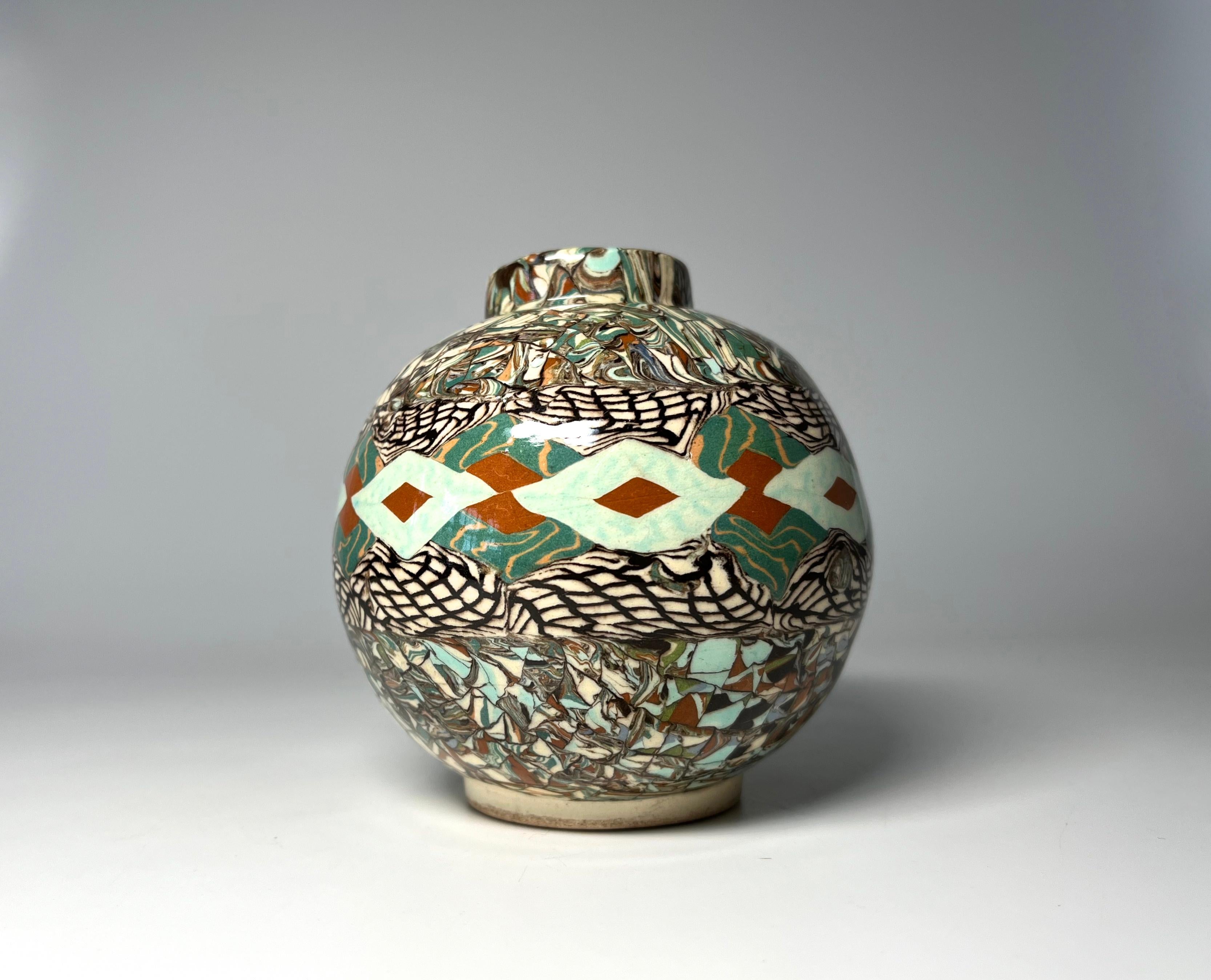 Jean Gerbino for Vallauris, France, ceramic glazed pale green and terracotta  mosaic vase 
Gerbino uses the Neriage technique to attain such intriguing patterns 
Circa 1960's
Signed Gerbino  to base
Height 3.75 inch, Diameter 3.5 inch, 
In very good