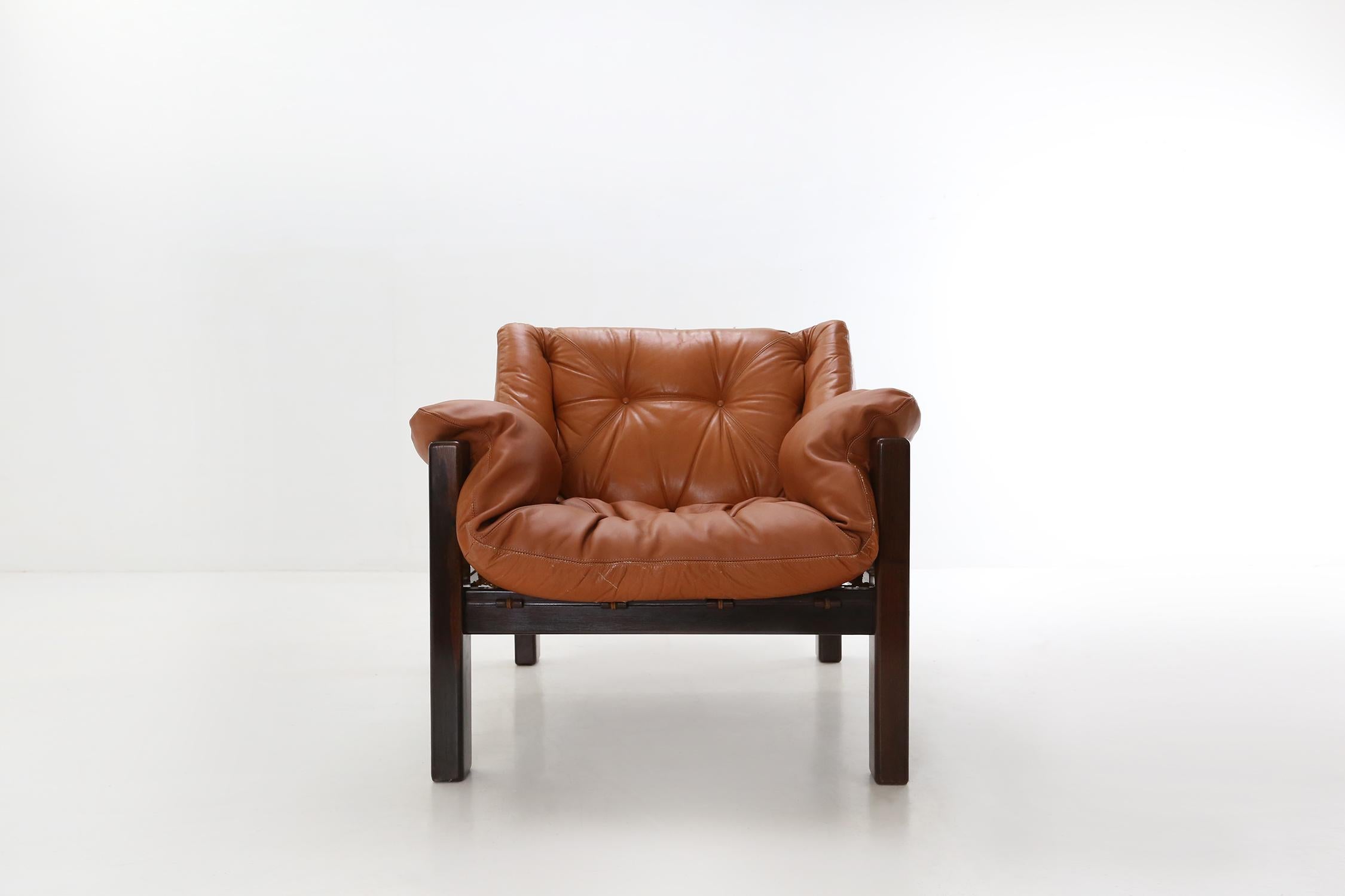 Brazilian amazonas armchair designed by Jean Gillon for Italma.
Made of jacaranda wooden frame and cognac colored leather.
The seat is partially (front) professionally upholstered.